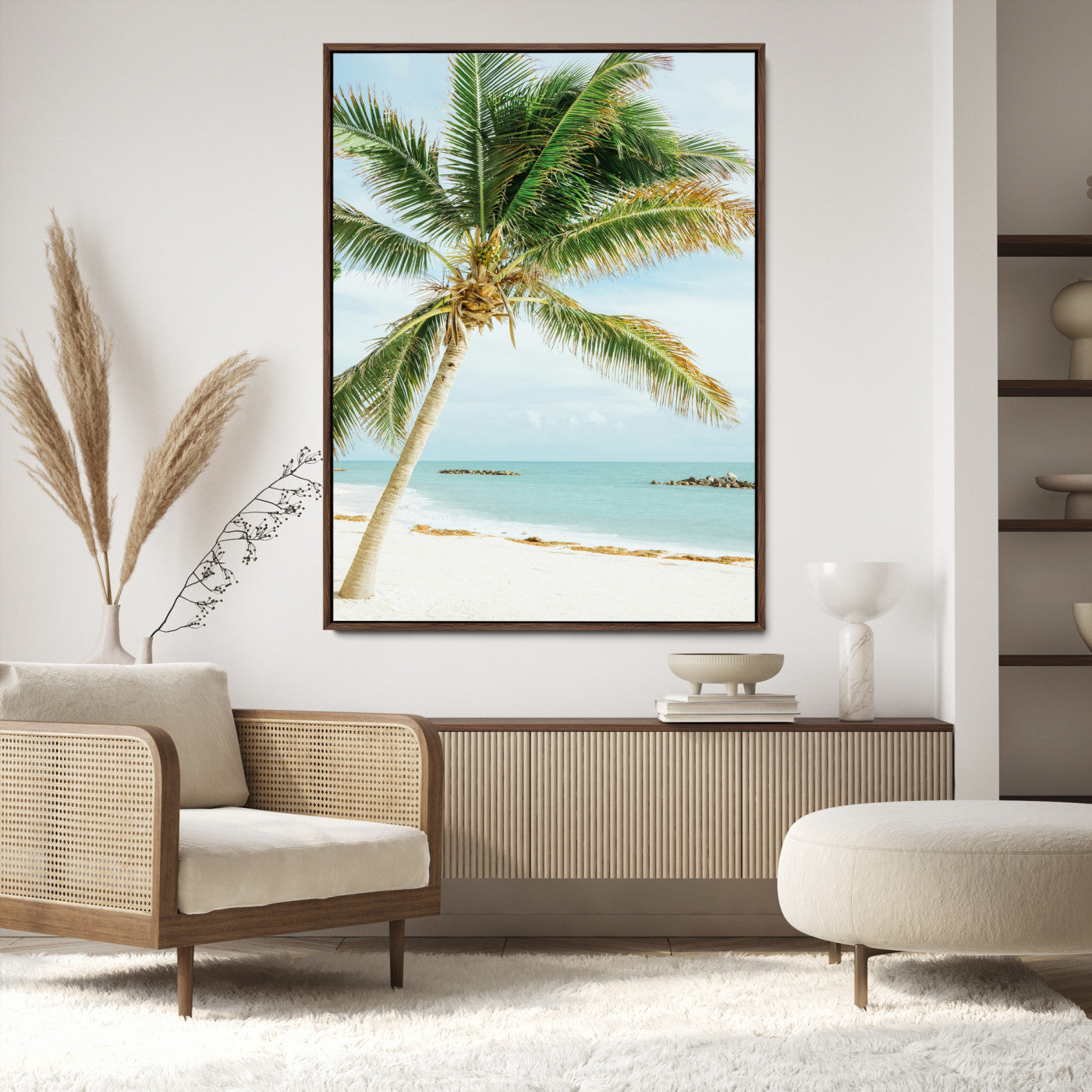 A tall palm tree leaning over a white sandy beach with turquoise ocean waves, creating a peaceful and tropical coastal scene.
