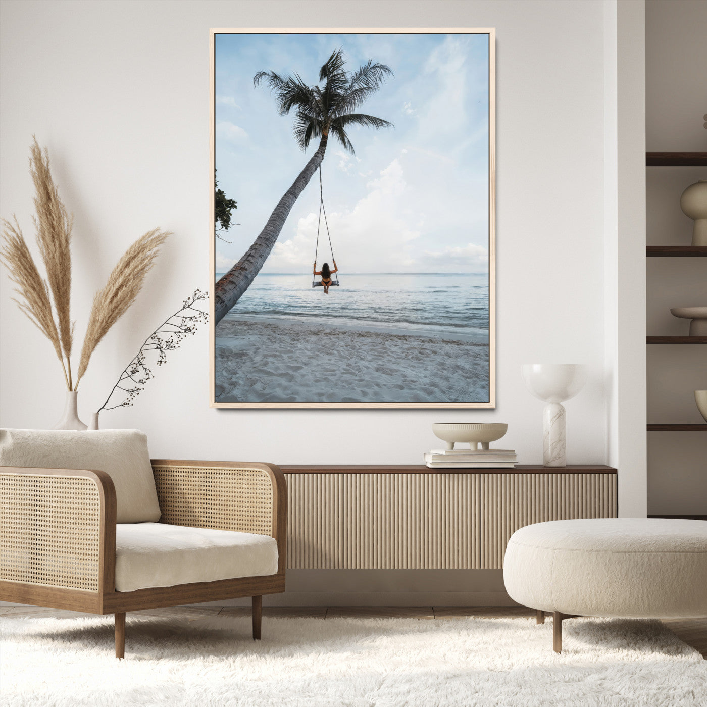 Wall art of a girl on a swing hanging from a palm tree over calm ocean waters, perfect for tropical or minimalist coastal decor.