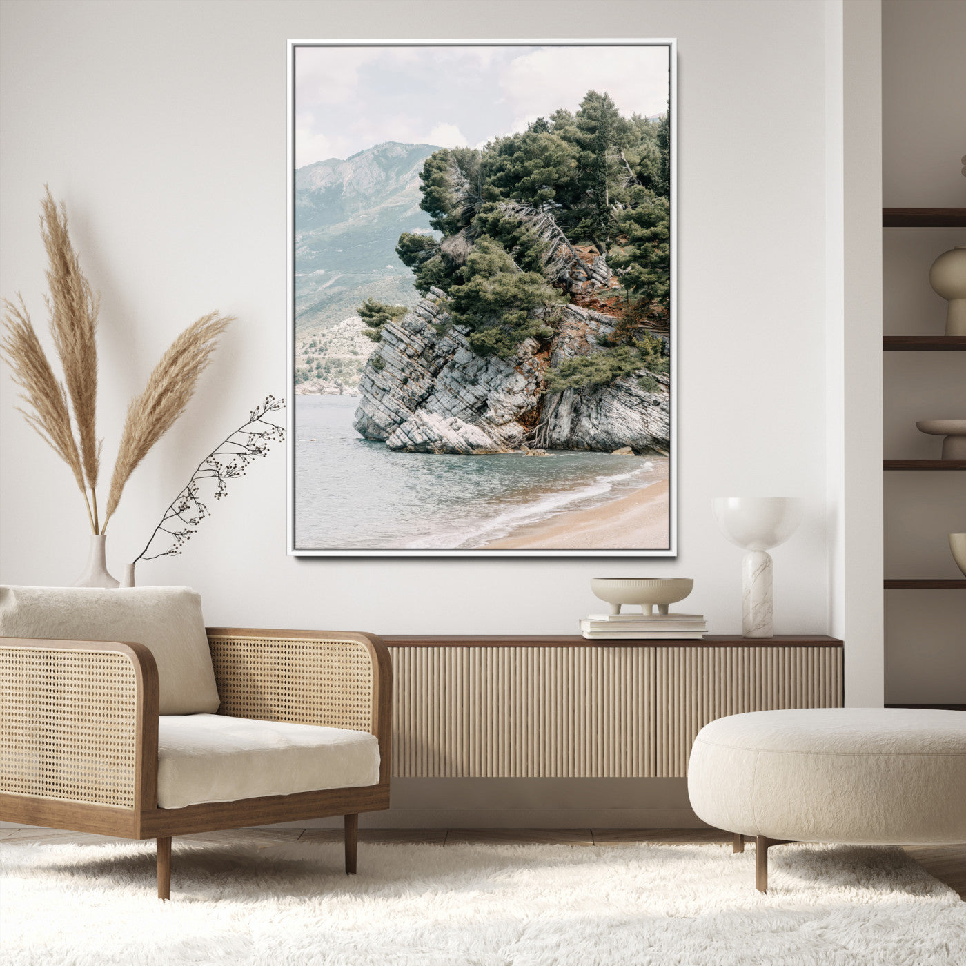 Framed photo of a rocky coastal cliff with dense greenery and calm shoreline, ideal for rustic coastal or earthy-toned home decor.