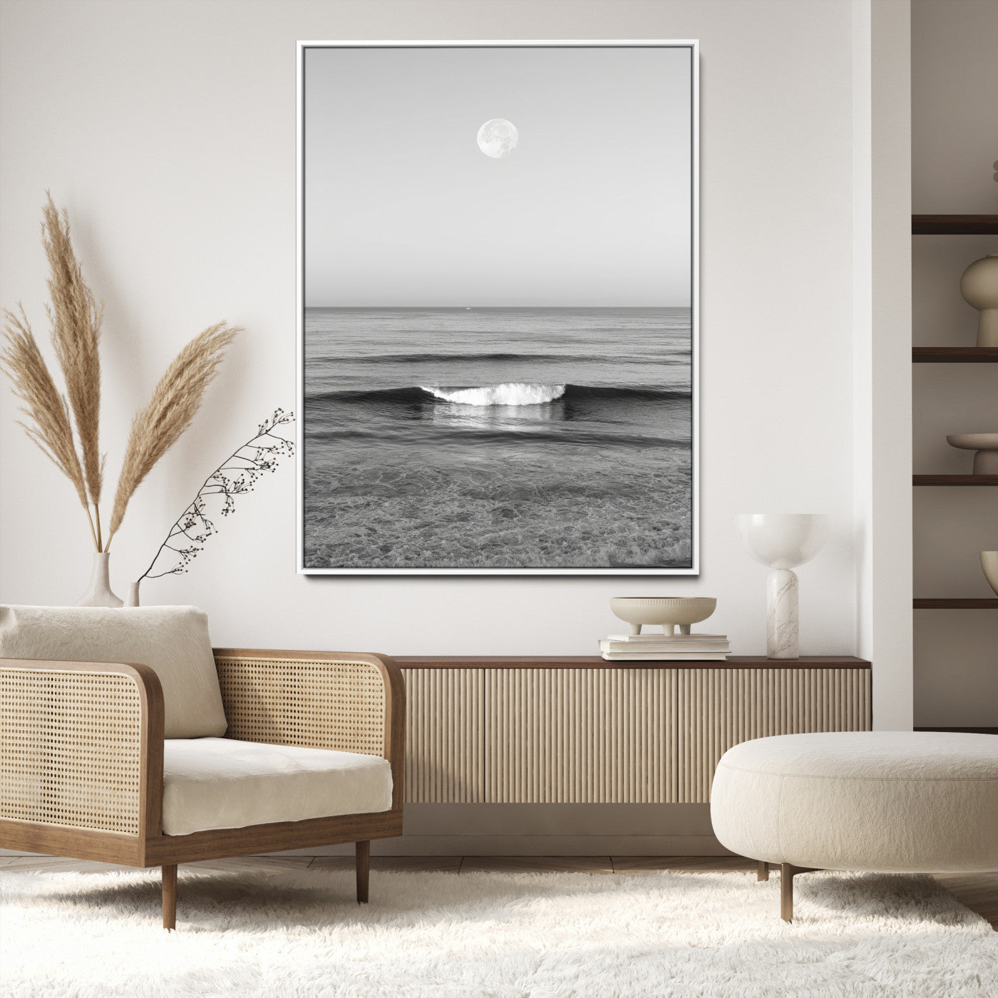 Black and white wall art of a calm ocean wave beneath a full moon, ideal for minimalist or monochrome coastal decor.