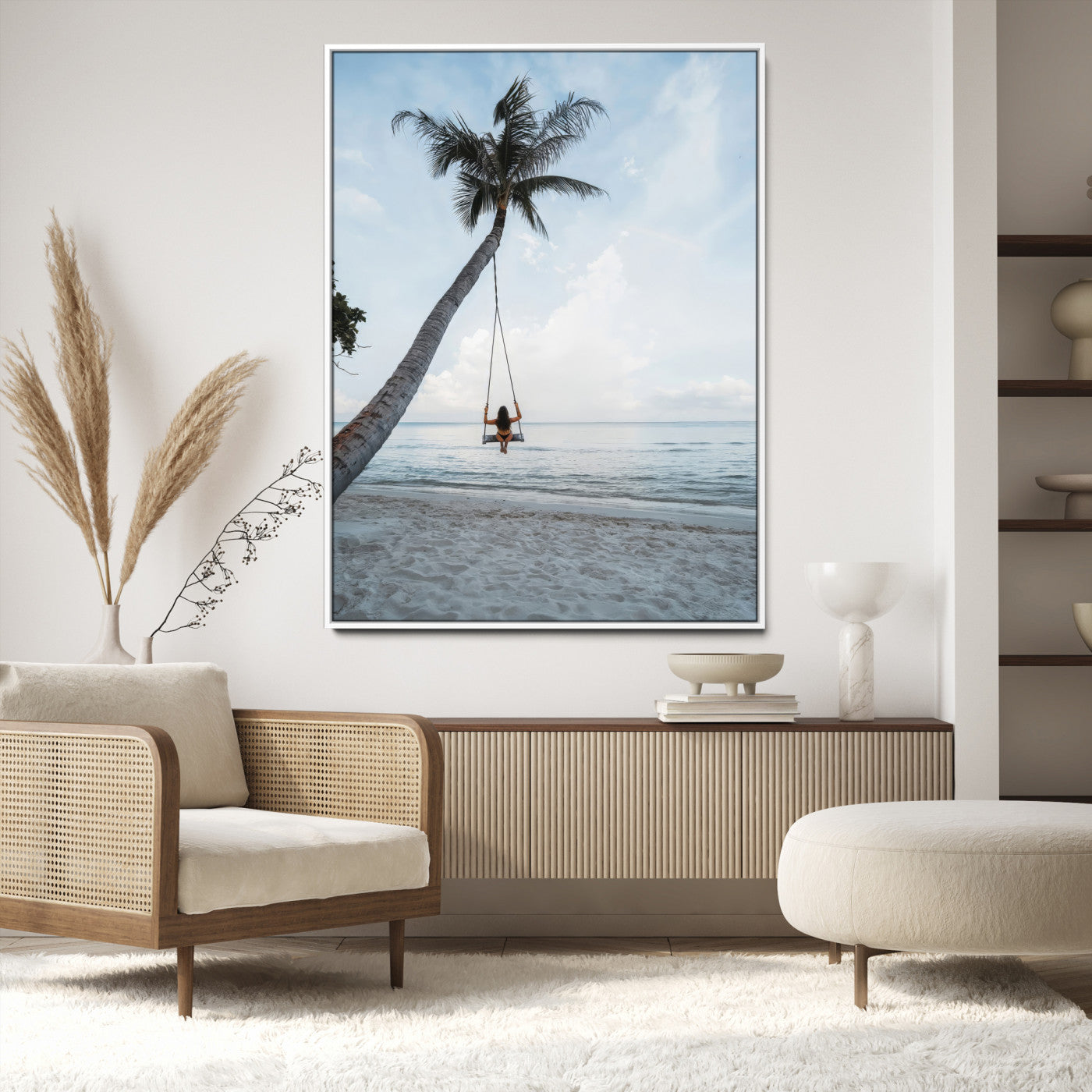 Wall art of a girl on a swing hanging from a palm tree over calm ocean waters, perfect for tropical or minimalist coastal decor.
