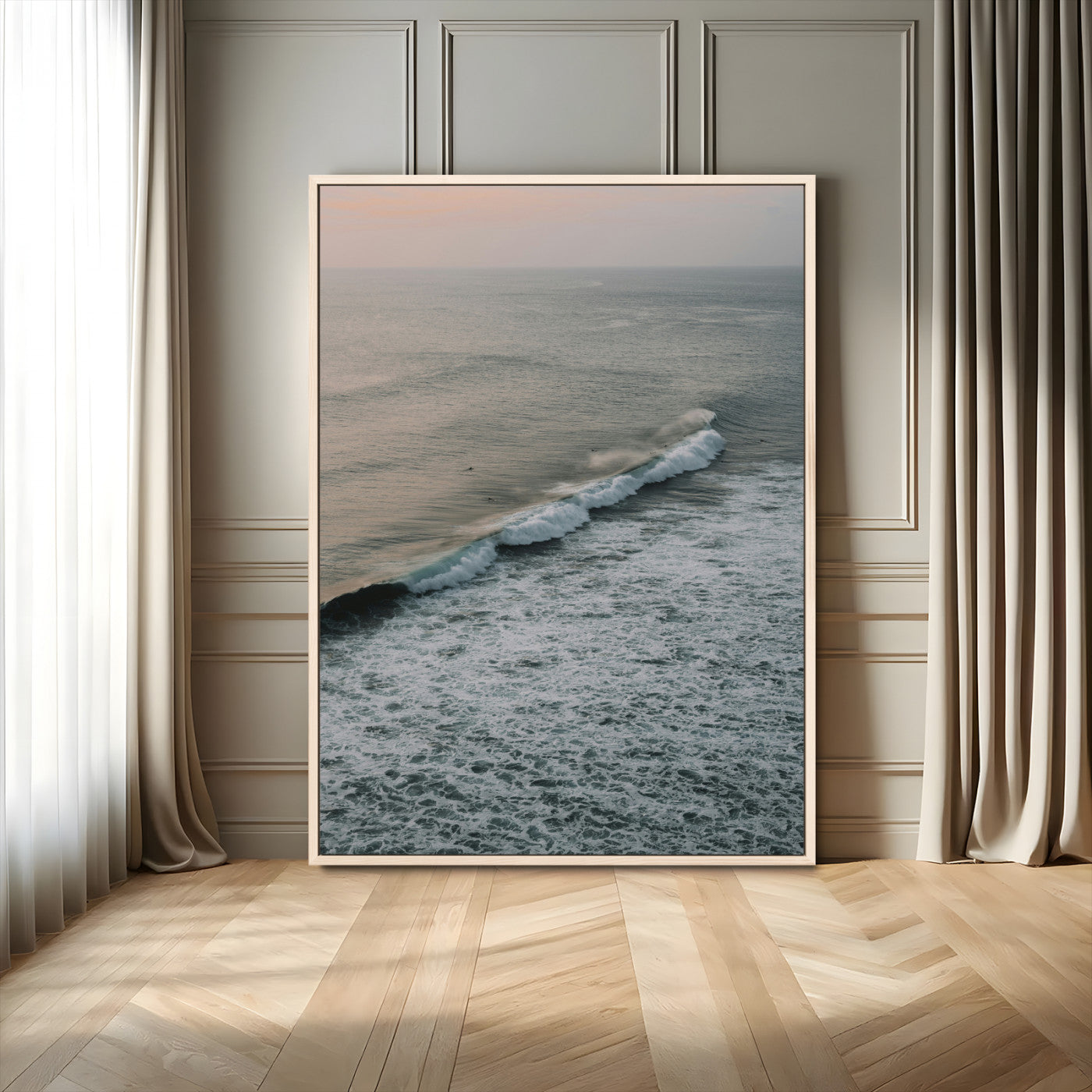 Aerial view of ocean waves rolling towards the shore under a soft sunset sky, creating a peaceful and minimalist coastal scene.