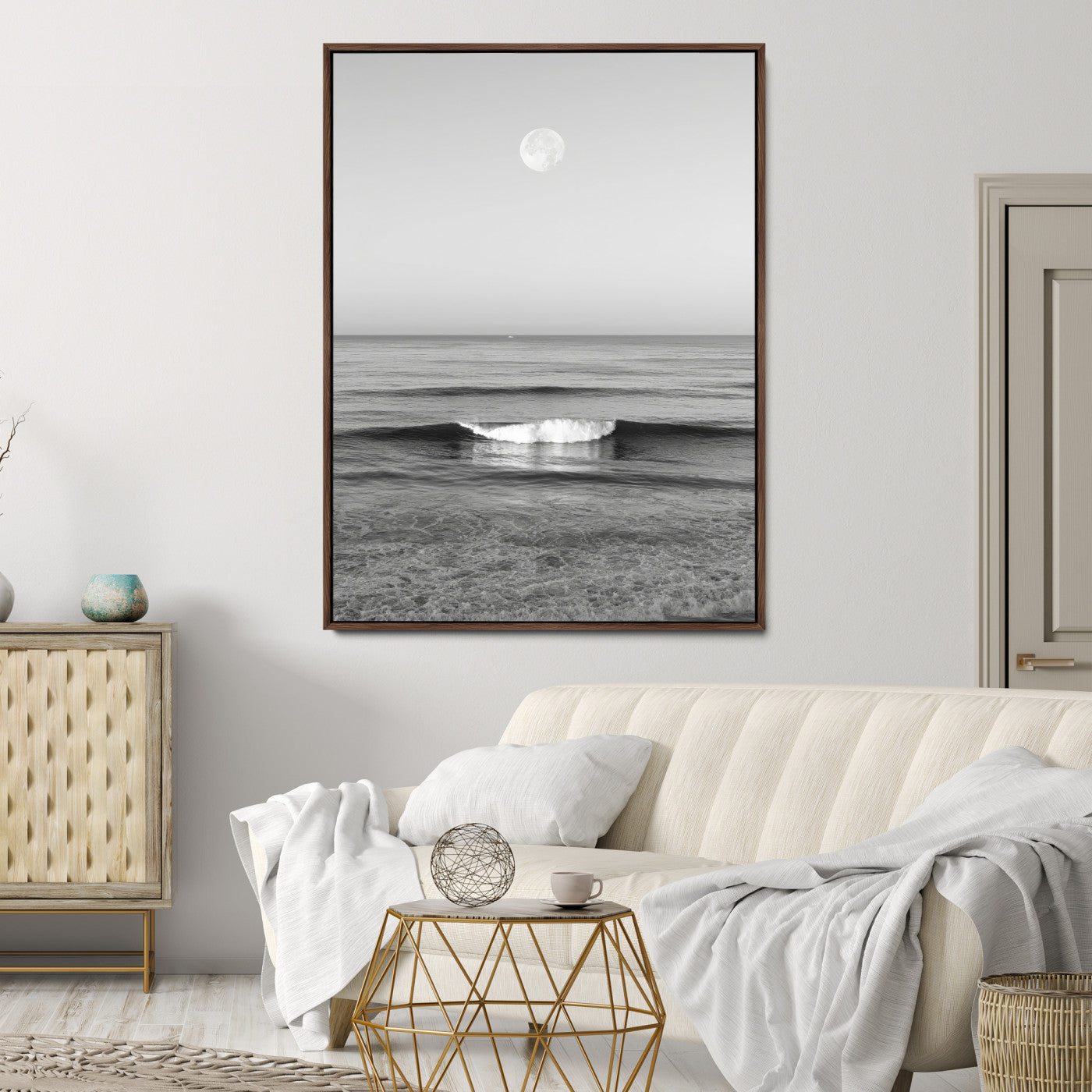 Black and white wall art of a calm ocean wave beneath a full moon, ideal for minimalist or monochrome coastal decor.