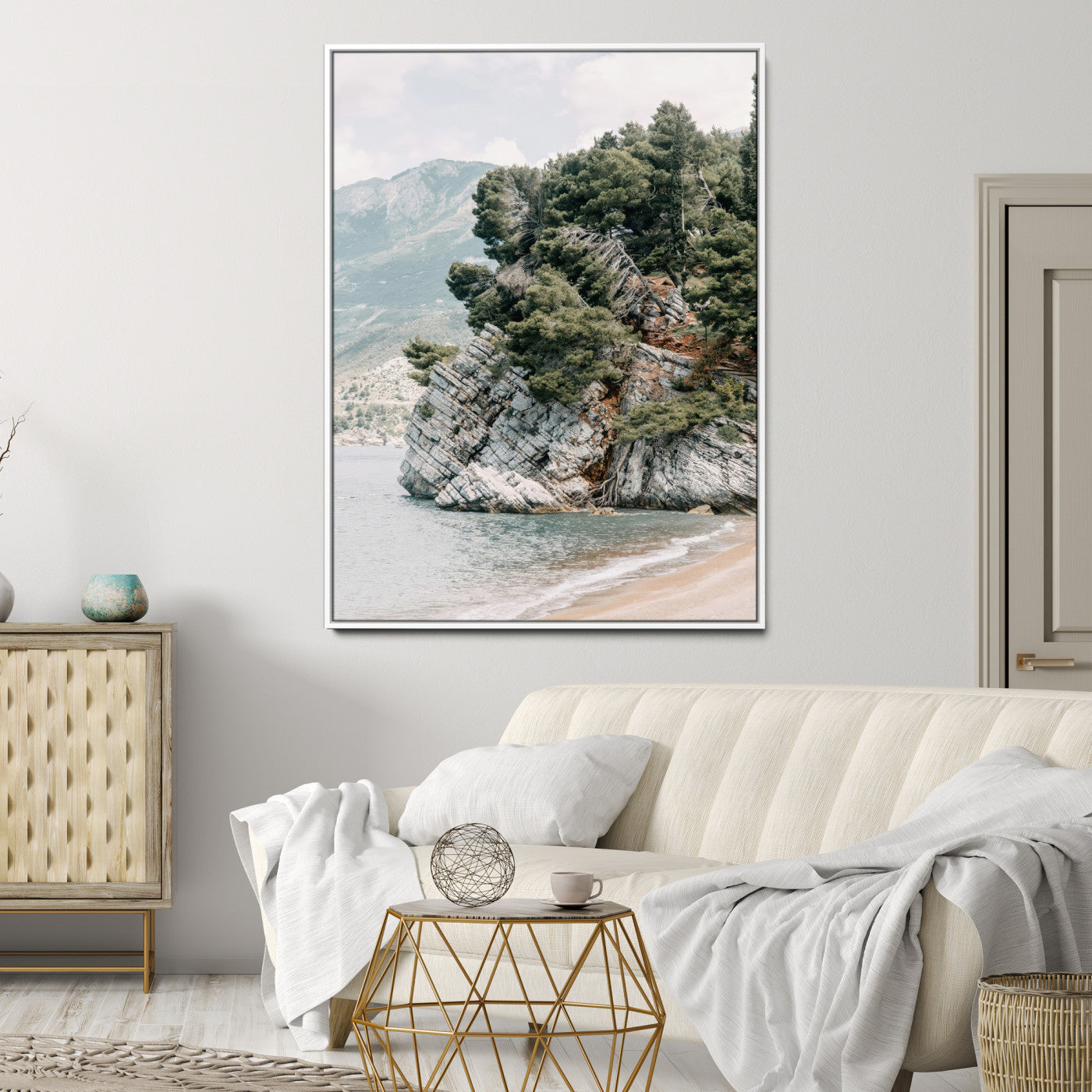 Framed photo of a rocky coastal cliff with dense greenery and calm shoreline, ideal for rustic coastal or earthy-toned home decor.