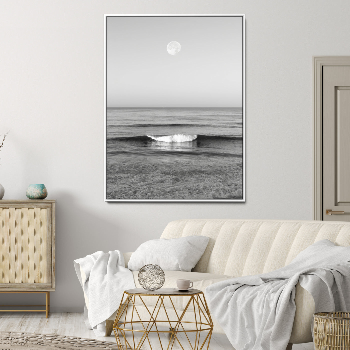 Black and white wall art of a calm ocean wave beneath a full moon, ideal for minimalist or monochrome coastal decor.