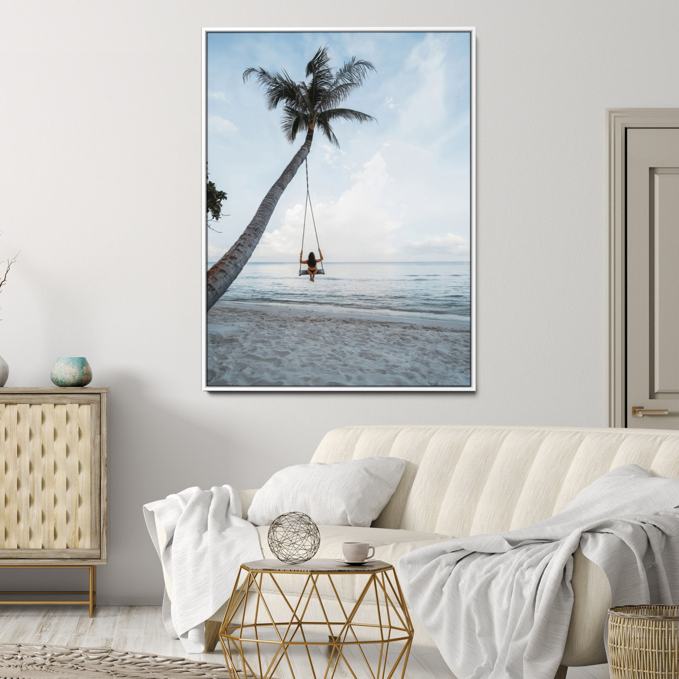 Wall art of a girl on a swing hanging from a palm tree over calm ocean waters, perfect for tropical or minimalist coastal decor.