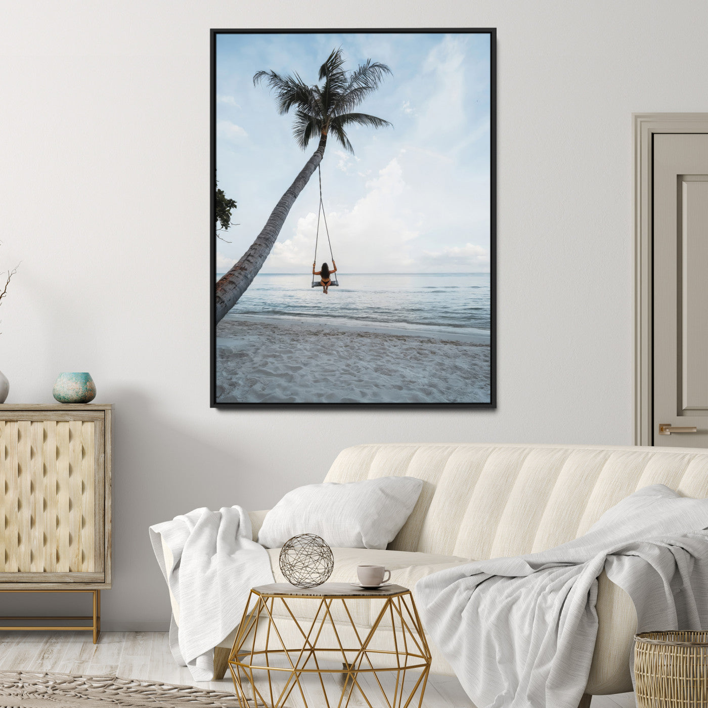Wall art of a girl on a swing hanging from a palm tree over calm ocean waters, perfect for tropical or minimalist coastal decor.