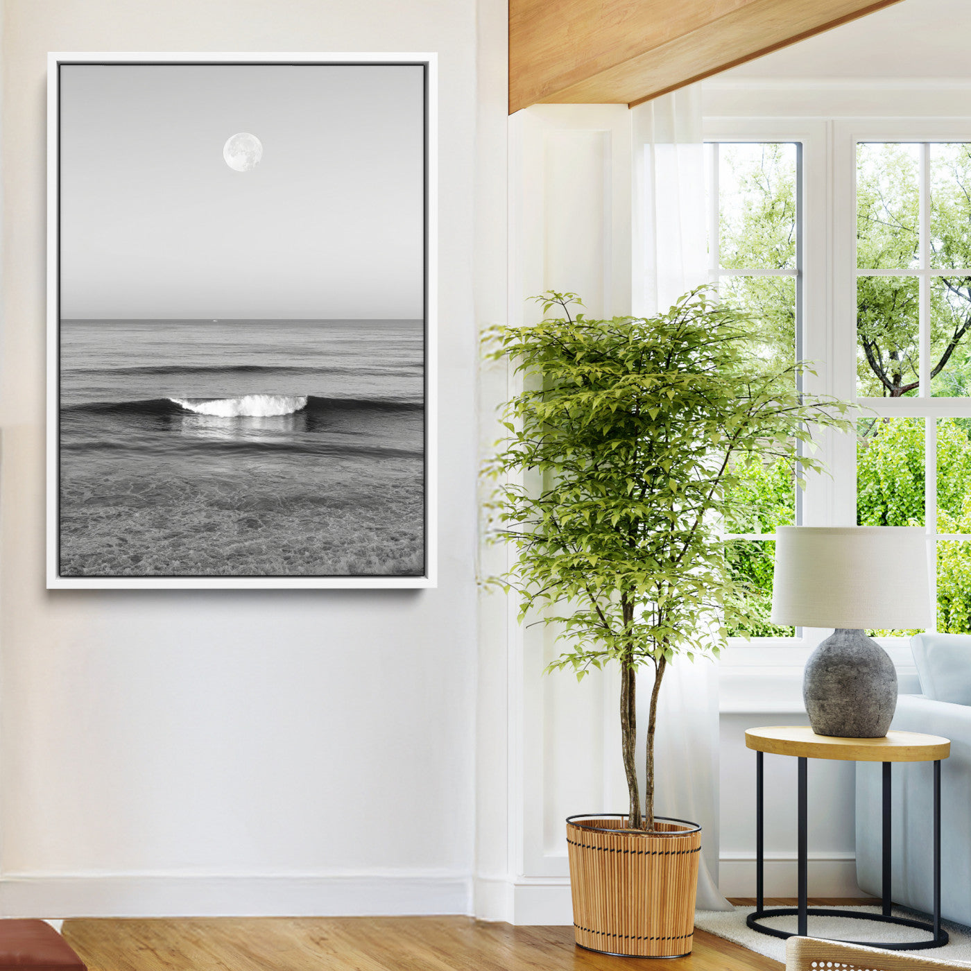 Black and white wall art of a calm ocean wave beneath a full moon, ideal for minimalist or monochrome coastal decor.