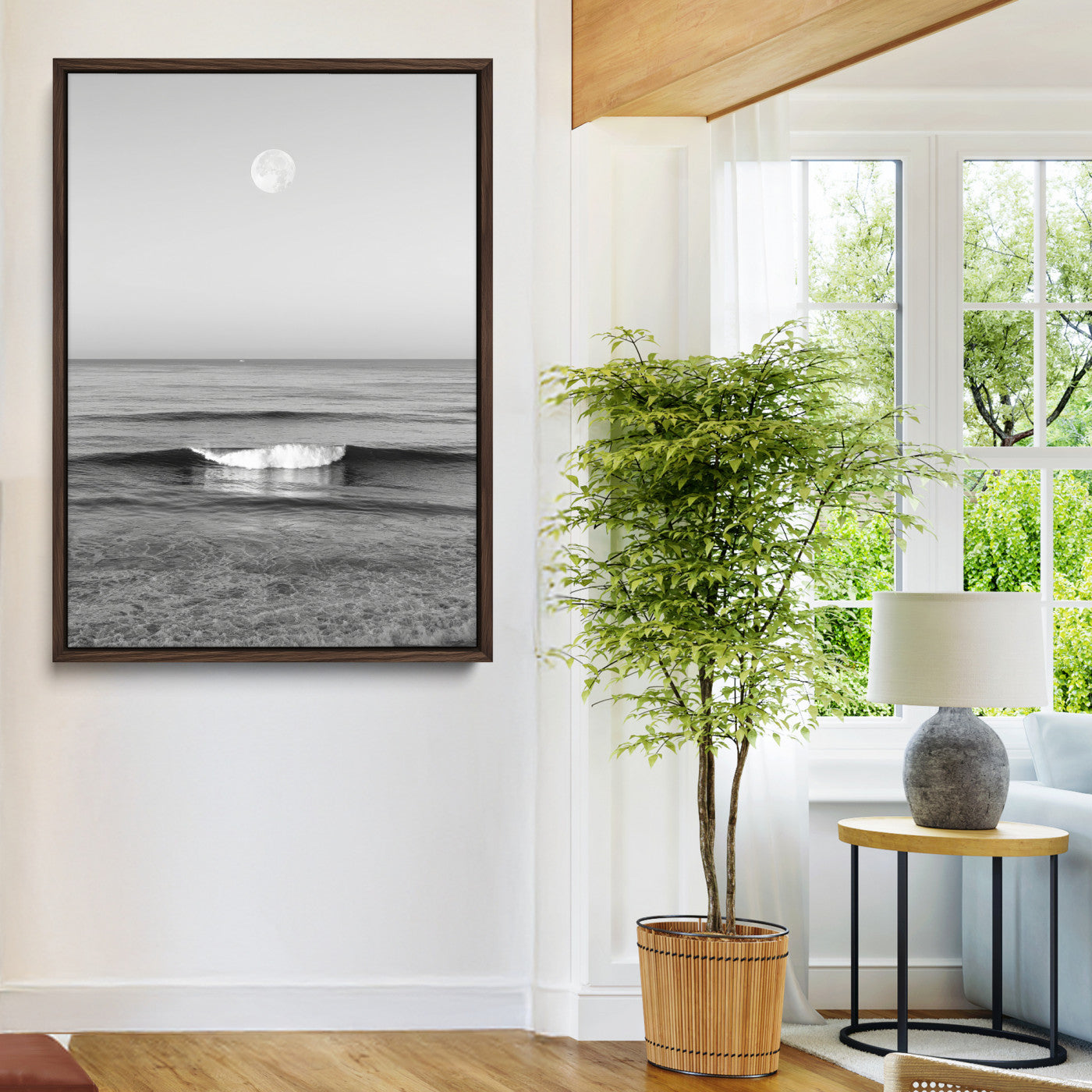 Black and white wall art of a calm ocean wave beneath a full moon, ideal for minimalist or monochrome coastal decor.