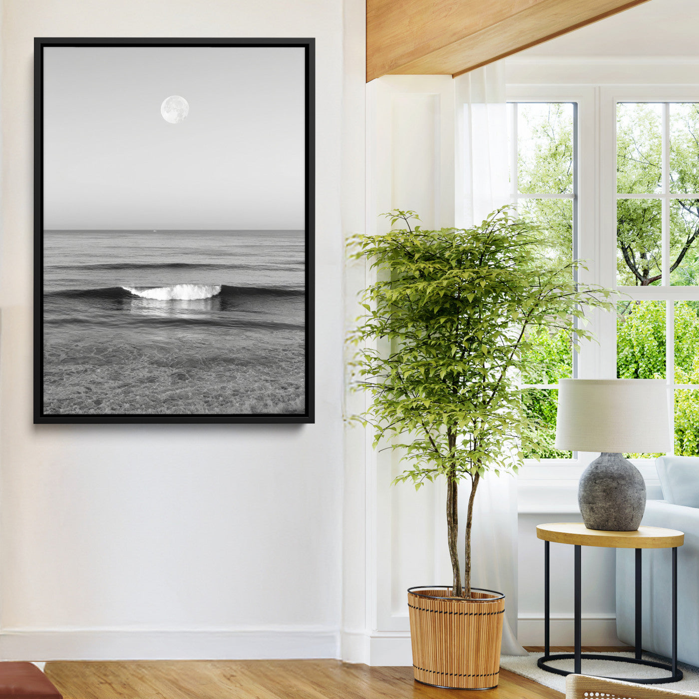Black and white wall art of a calm ocean wave beneath a full moon, ideal for minimalist or monochrome coastal decor.