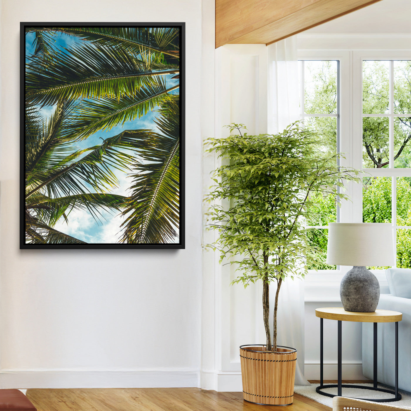 Looking up at lush green palm leaves against a bright blue sky, creating a tropical and relaxing coastal aesthetic.
