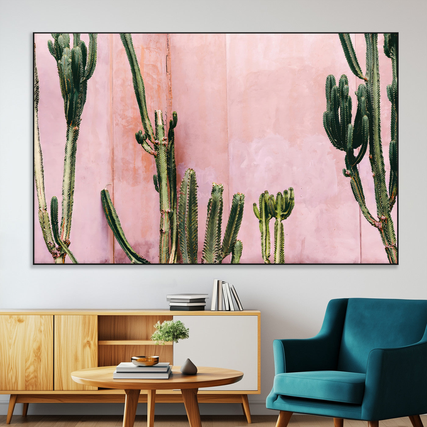 Framed canvas of tall green cacti against a soft pink wall, ideal for modern desert or colorful southwest-inspired home decor.