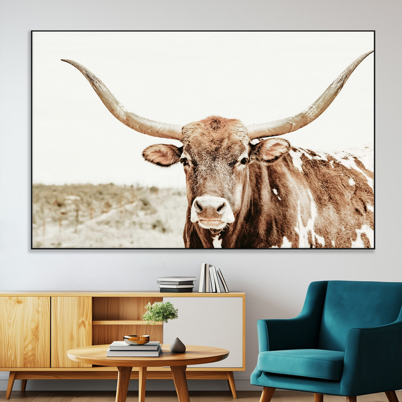 A Texas longhorn bull with wide horns, standing in a dry field under soft light, ideal for rustic farmhouse or western-themed interiors.