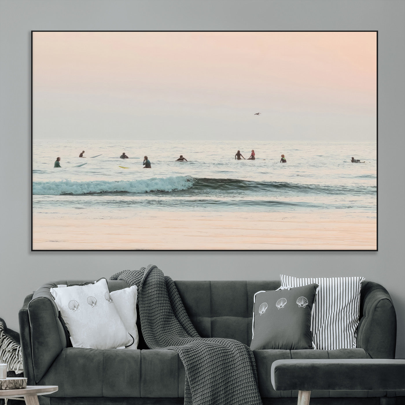 Dreamy photo of surfers waiting on soft pastel waves under a pink sunset sky, ideal for soft coastal minimalist or serene ocean-themed home decor.