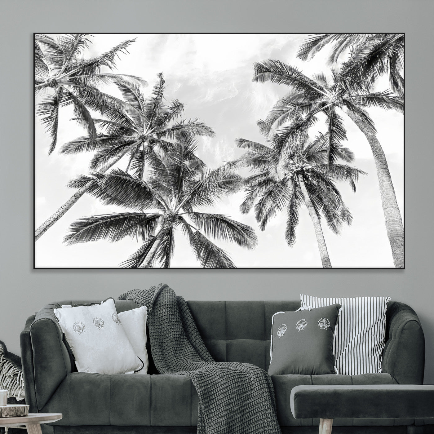 Black and white tropical palm trees viewed from below, swaying gently against a bright sky, creating a serene and elegant coastal atmosphere.