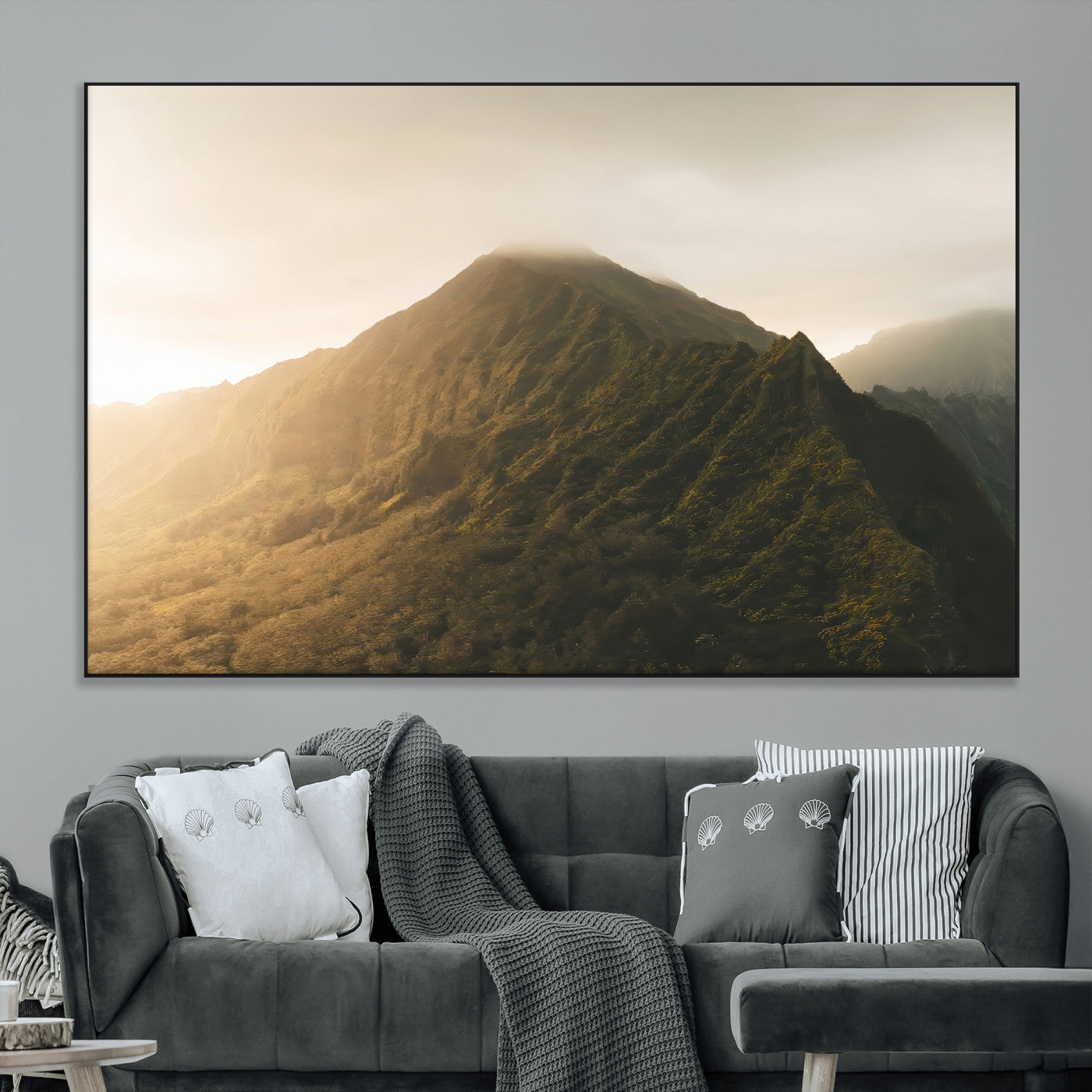 Sunlit mountain peak with mist rolling over its rugged slopes, bathed in golden light, creating a warm and tranquil nature-inspired scene.