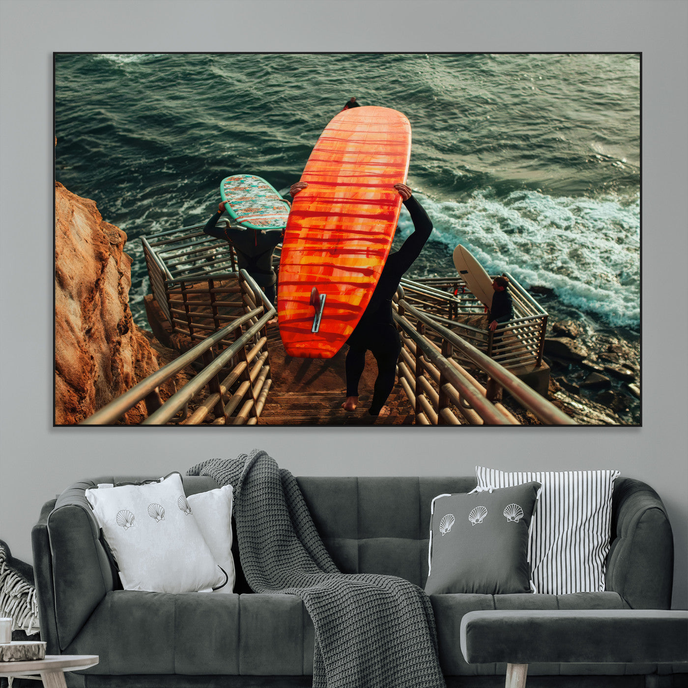 A surfer carrying a bold orange surfboard down a rugged staircase toward the ocean, bathed in golden hour light, capturing the energy of coastal adventure.