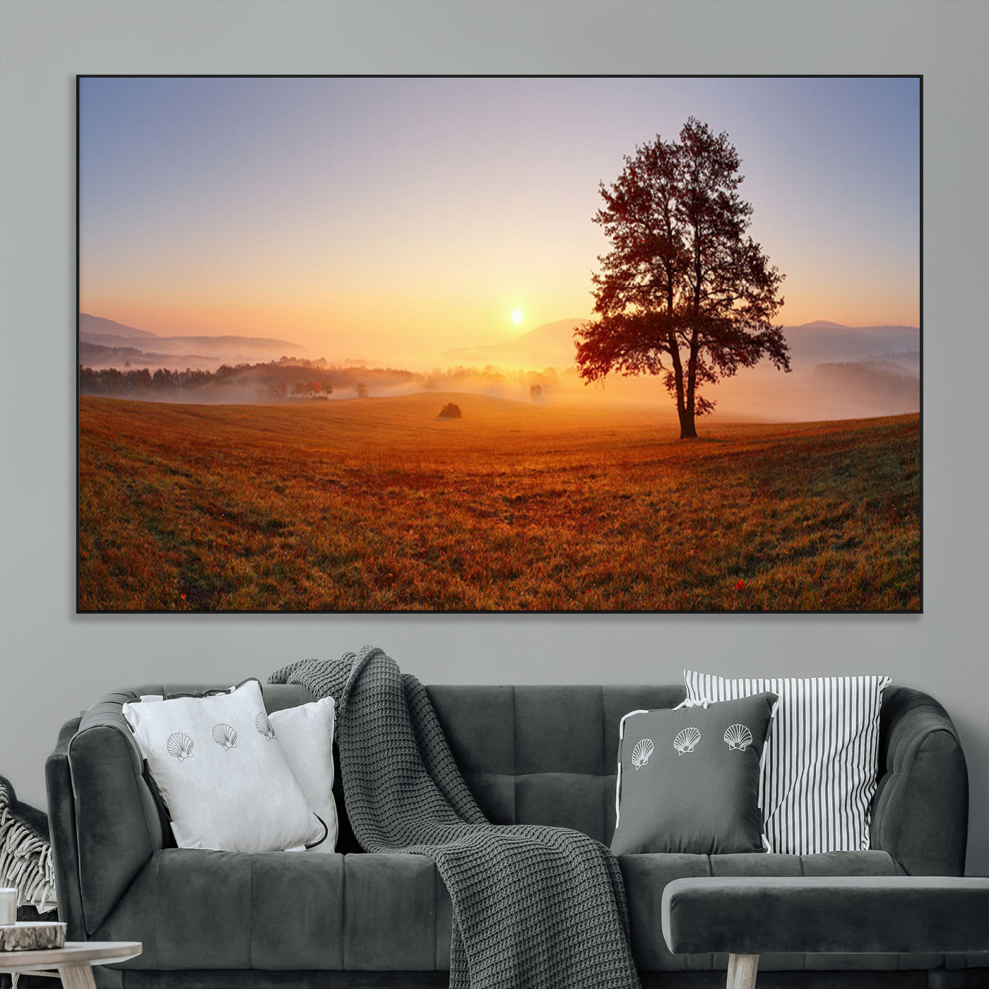 A tranquil landscape at sunrise with a mist-covered field and a lone tree, creating a peaceful and natural atmosphere.