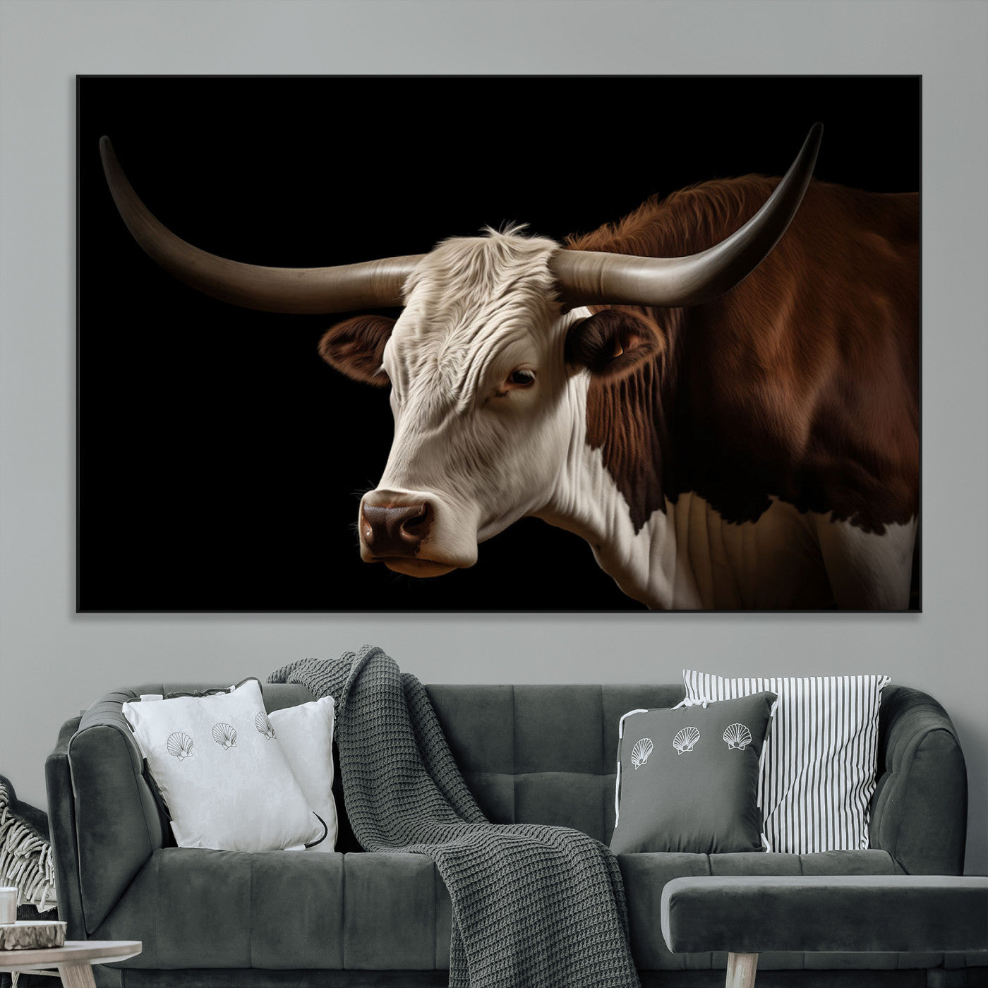 "Close-up of a brown and white longhorn cow with prominent curved horns against a black background."