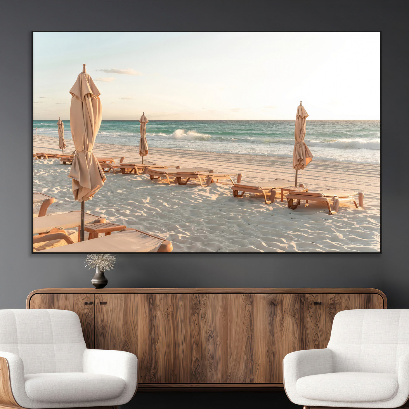 Minimalist photo of empty beach loungers and umbrellas on soft sand, ideal for calm seaside or pastel coastal-style home decor.