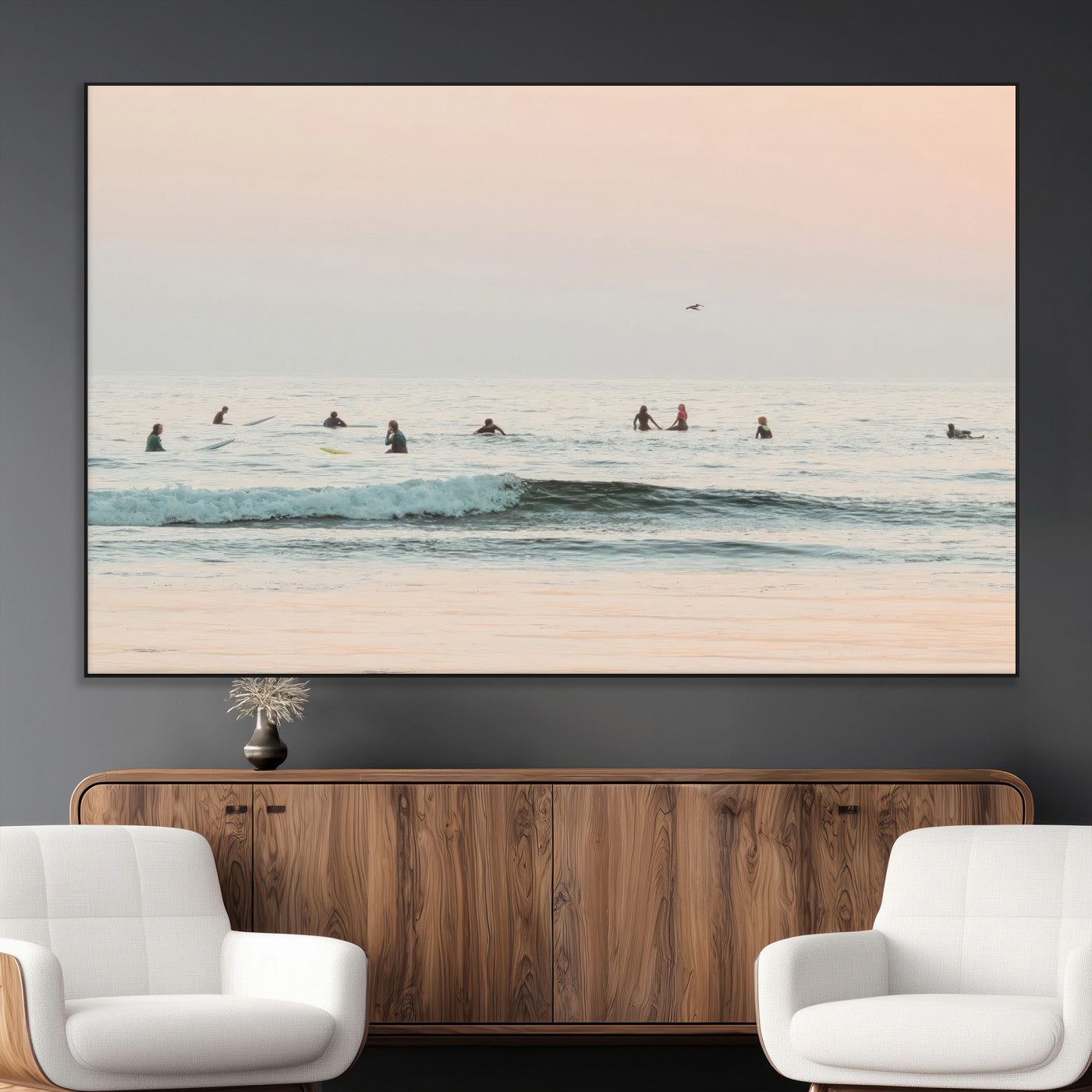 Dreamy photo of surfers waiting on soft pastel waves under a pink sunset sky, ideal for soft coastal minimalist or serene ocean-themed home decor.