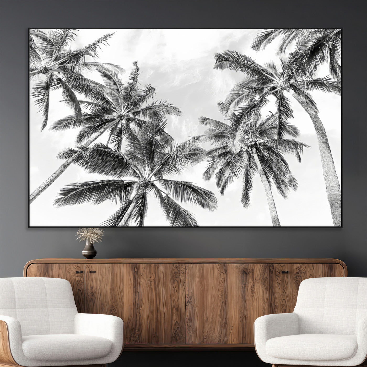 Black and white tropical palm trees viewed from below, swaying gently against a bright sky, creating a serene and elegant coastal atmosphere.