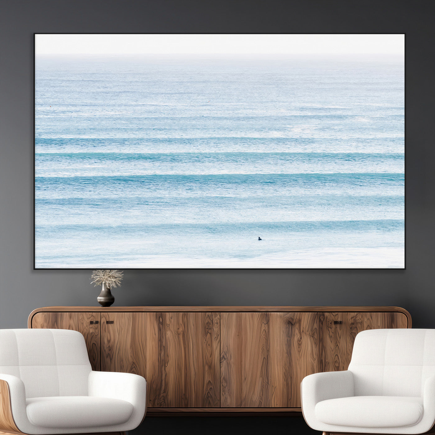 Minimalist ocean view with soft blue waves and a lone surfer, creating a serene and airy coastal aesthetic, perfect for tranquil home decor.