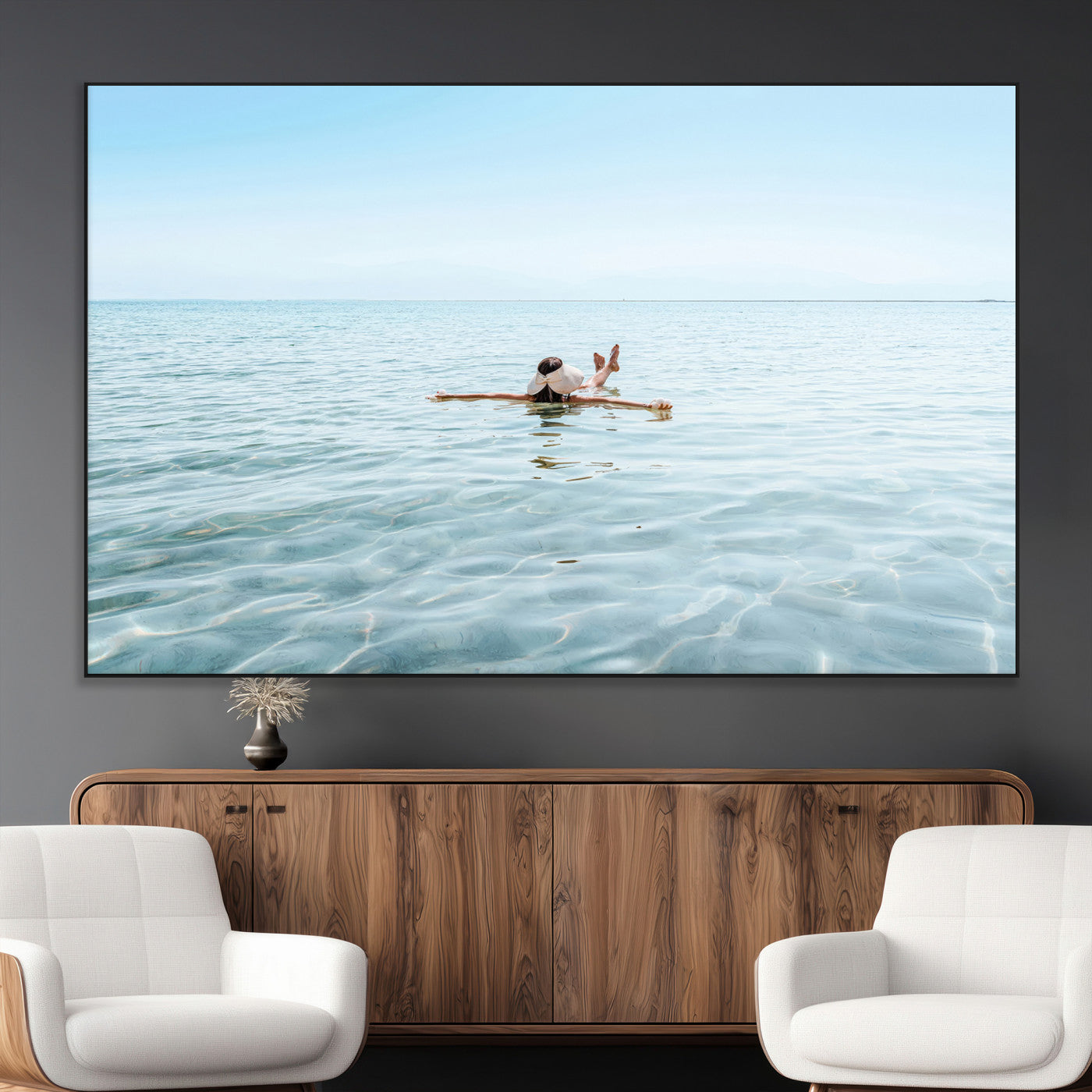 A peaceful minimalist scene of a person floating on crystal-clear water, surrounded by a vast open horizon, capturing relaxation and serenity in a tranquil aquatic setting.