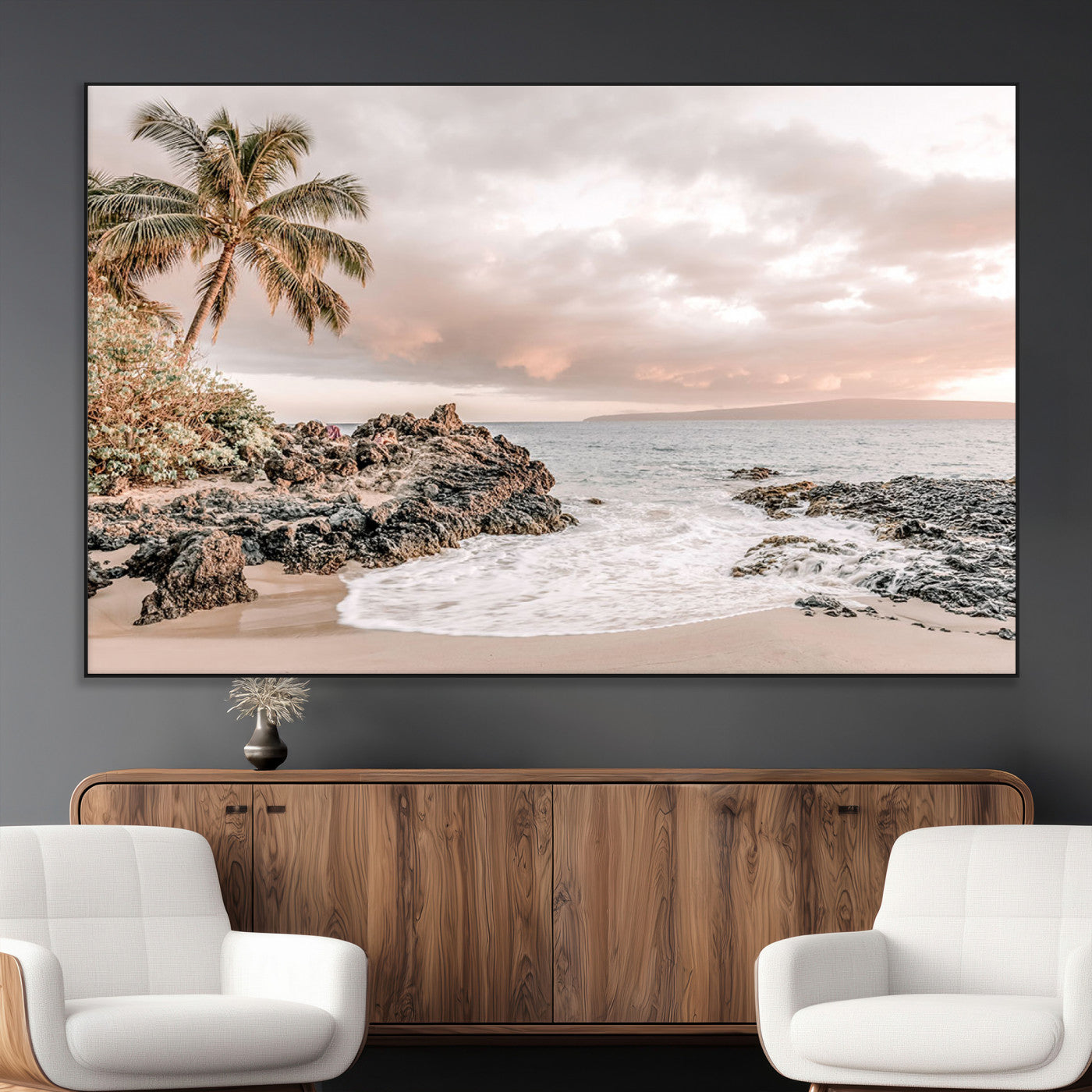 A peaceful beach scene with a palm tree and rocks, soft waves washing onto the shore under a soft pastel sky at sunset.