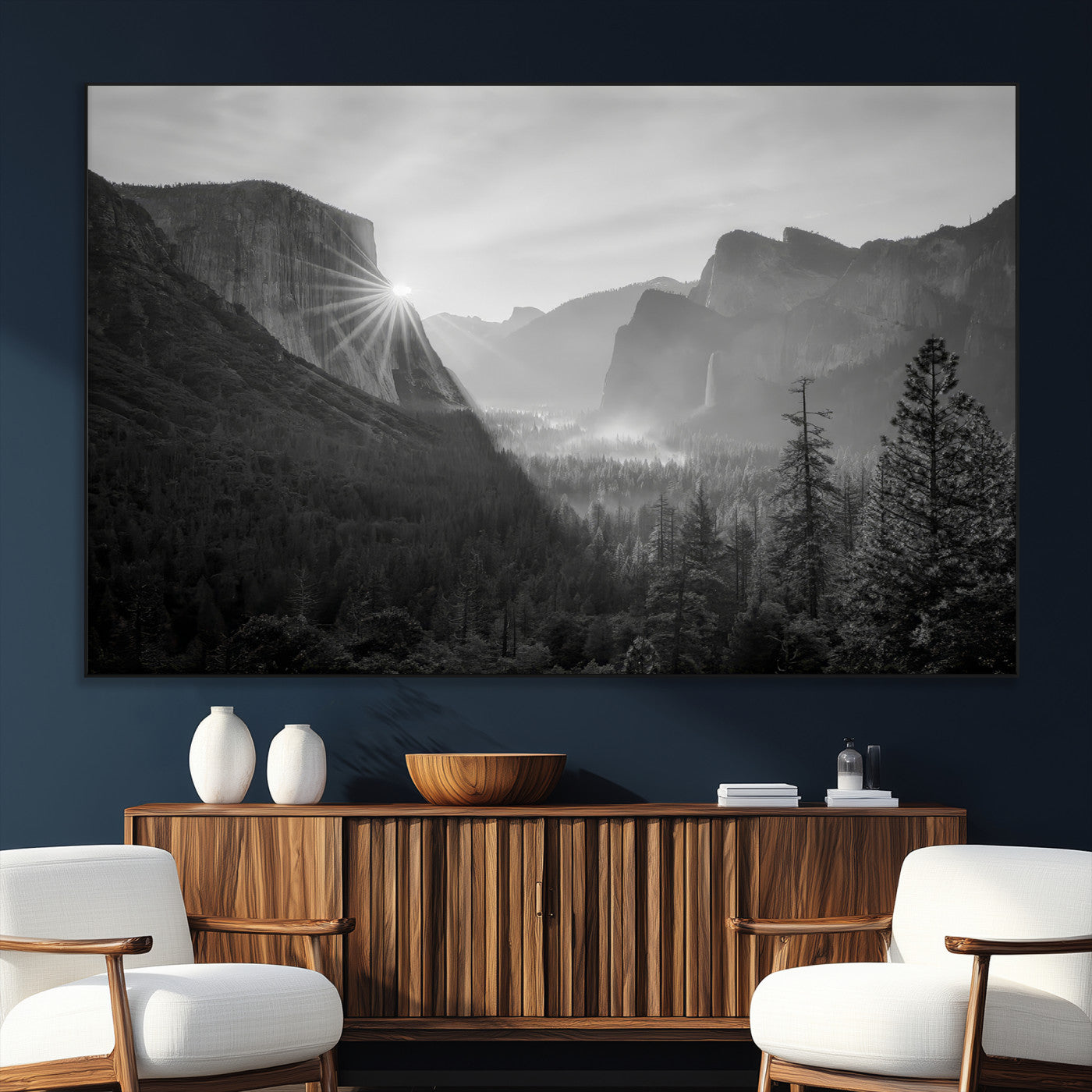 Black and white landscape of Yosemite with sun rays peeking over El Capitan, ideal for moody nature or modern rustic decor.