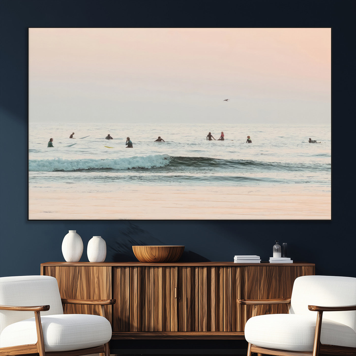 Dreamy photo of surfers waiting on soft pastel waves under a pink sunset sky, ideal for soft coastal minimalist or serene ocean-themed home decor.