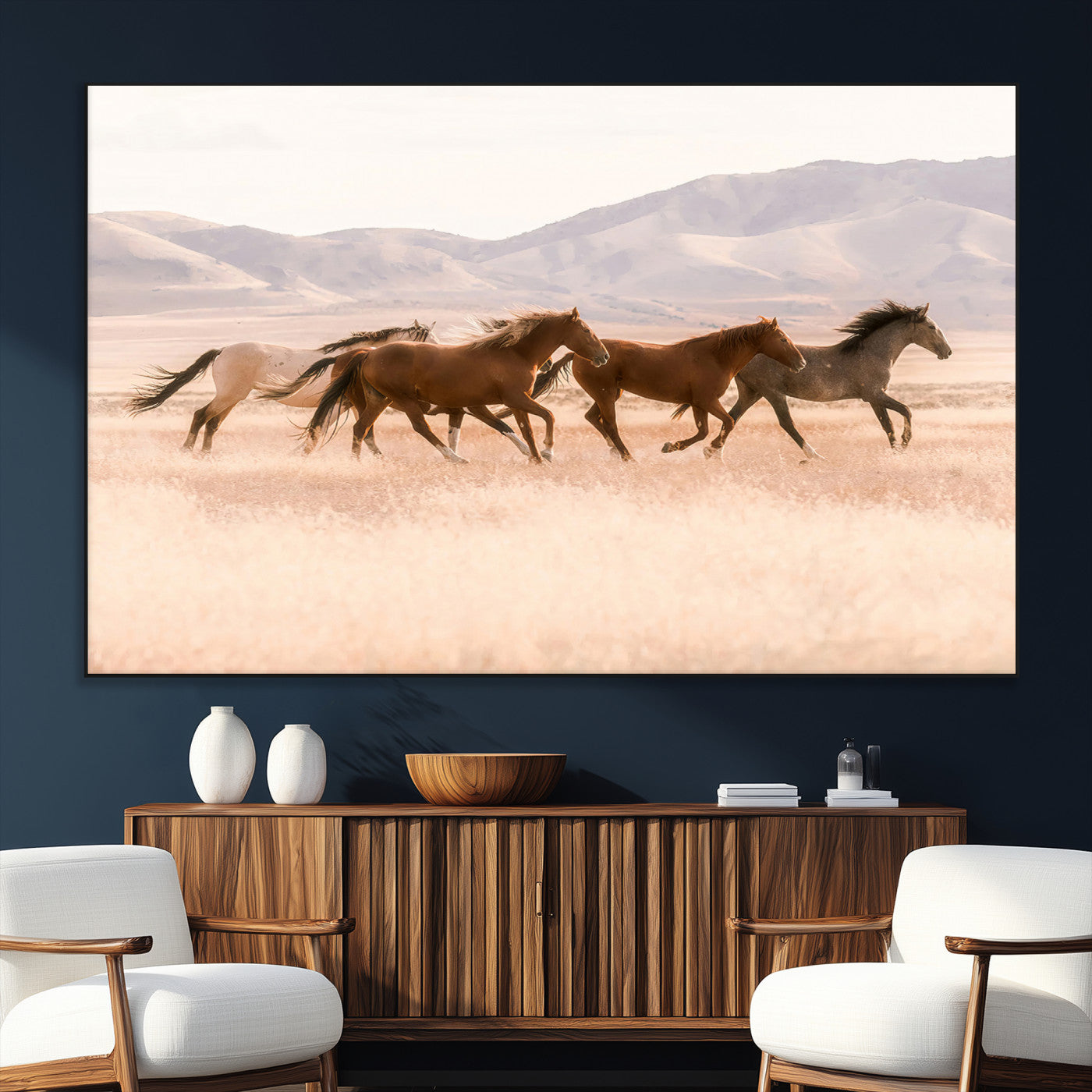 A herd of wild horses galloping through a sunlit desert plain with mountains in the background, perfect for rustic or western-themed wall decor.