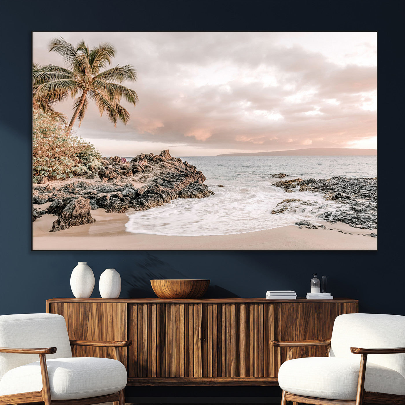 A peaceful beach scene with a palm tree and rocks, soft waves washing onto the shore under a soft pastel sky at sunset.