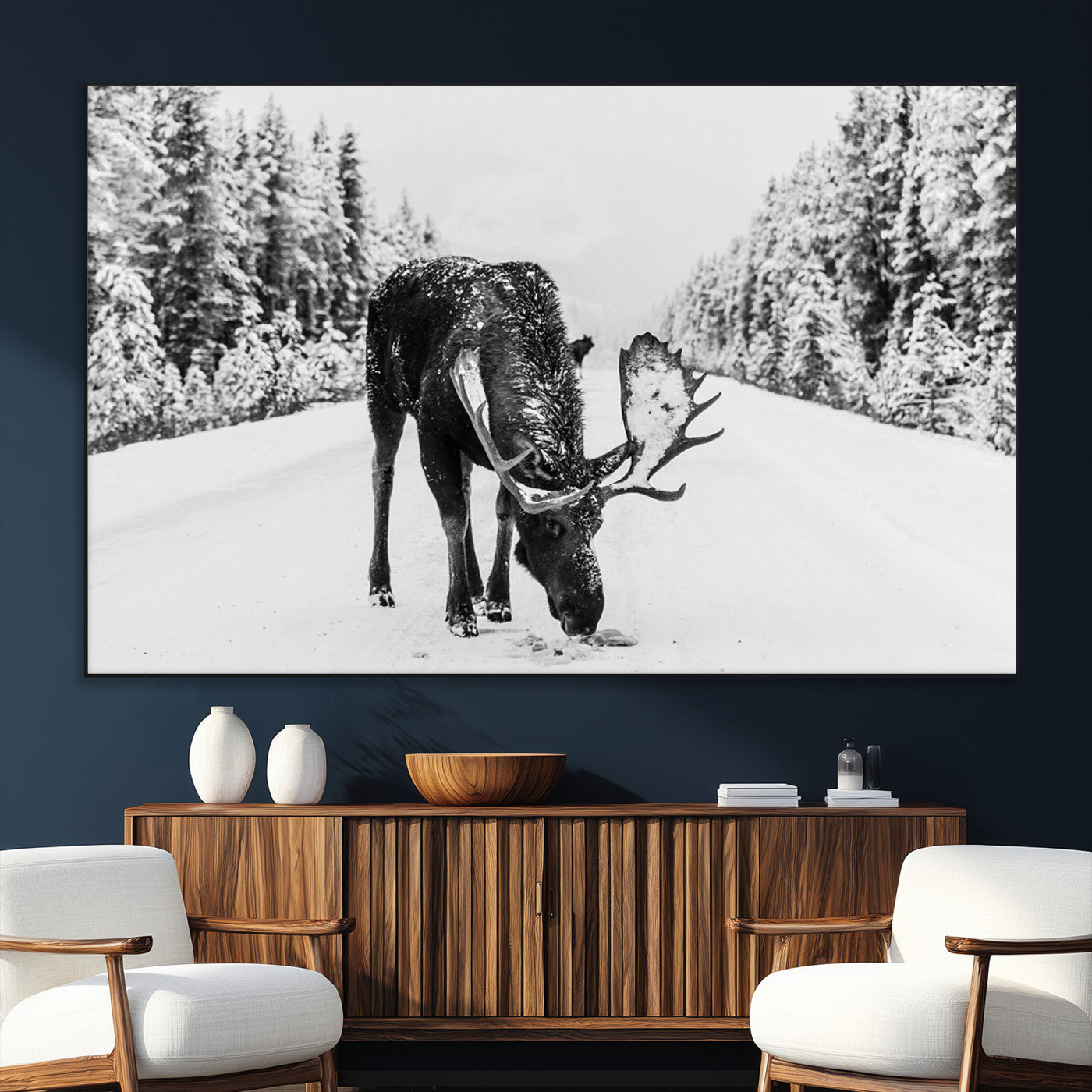 A majestic moose grazing in the snow-covered wilderness, surrounded by snow-covered trees, creating a peaceful winter scene.