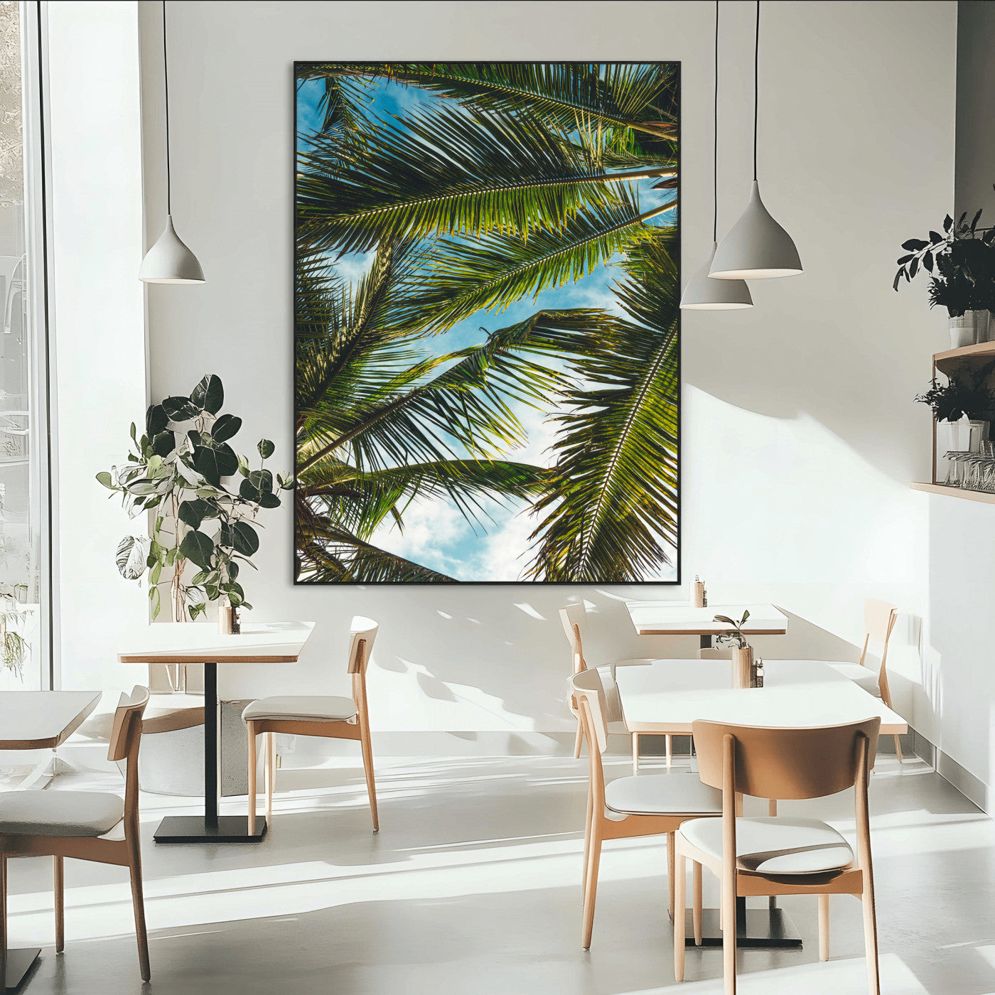 Looking up at lush green palm leaves against a bright blue sky, creating a tropical and relaxing coastal aesthetic.