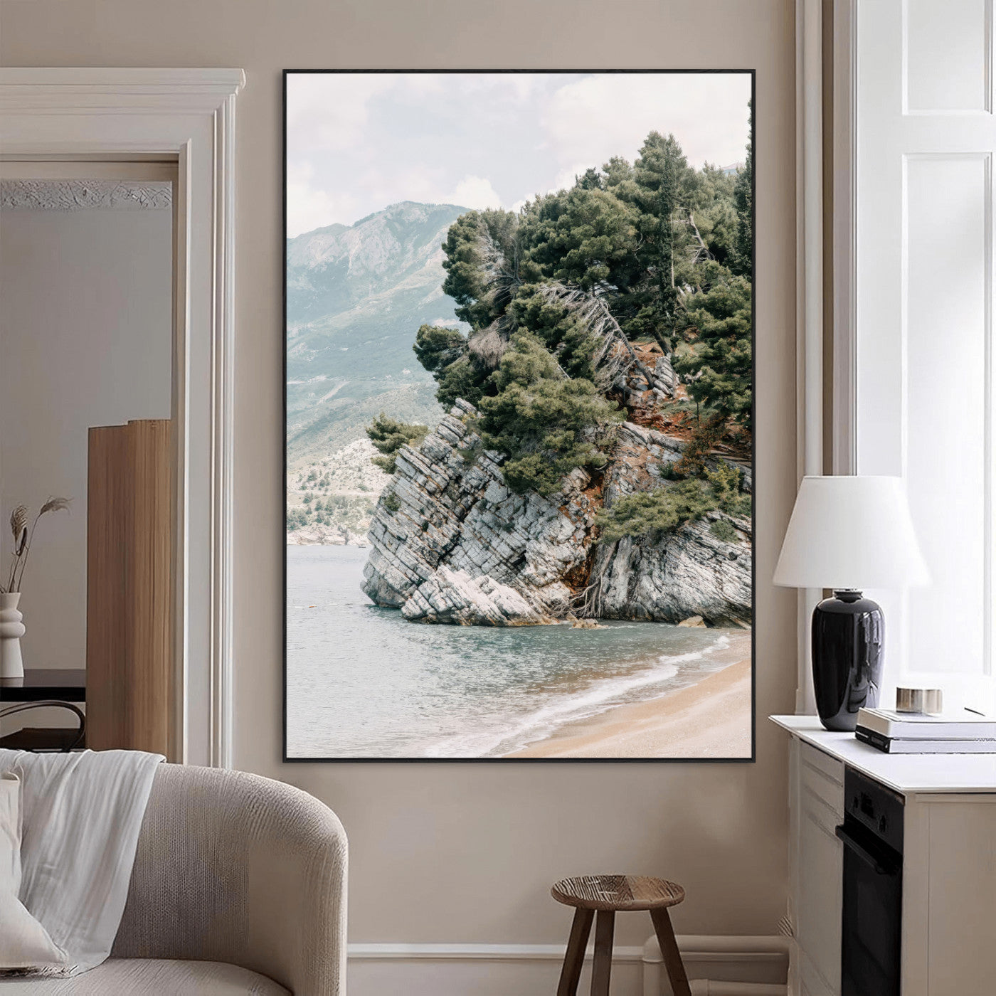 Framed photo of a rocky coastal cliff with dense greenery and calm shoreline, ideal for rustic coastal or earthy-toned home decor.