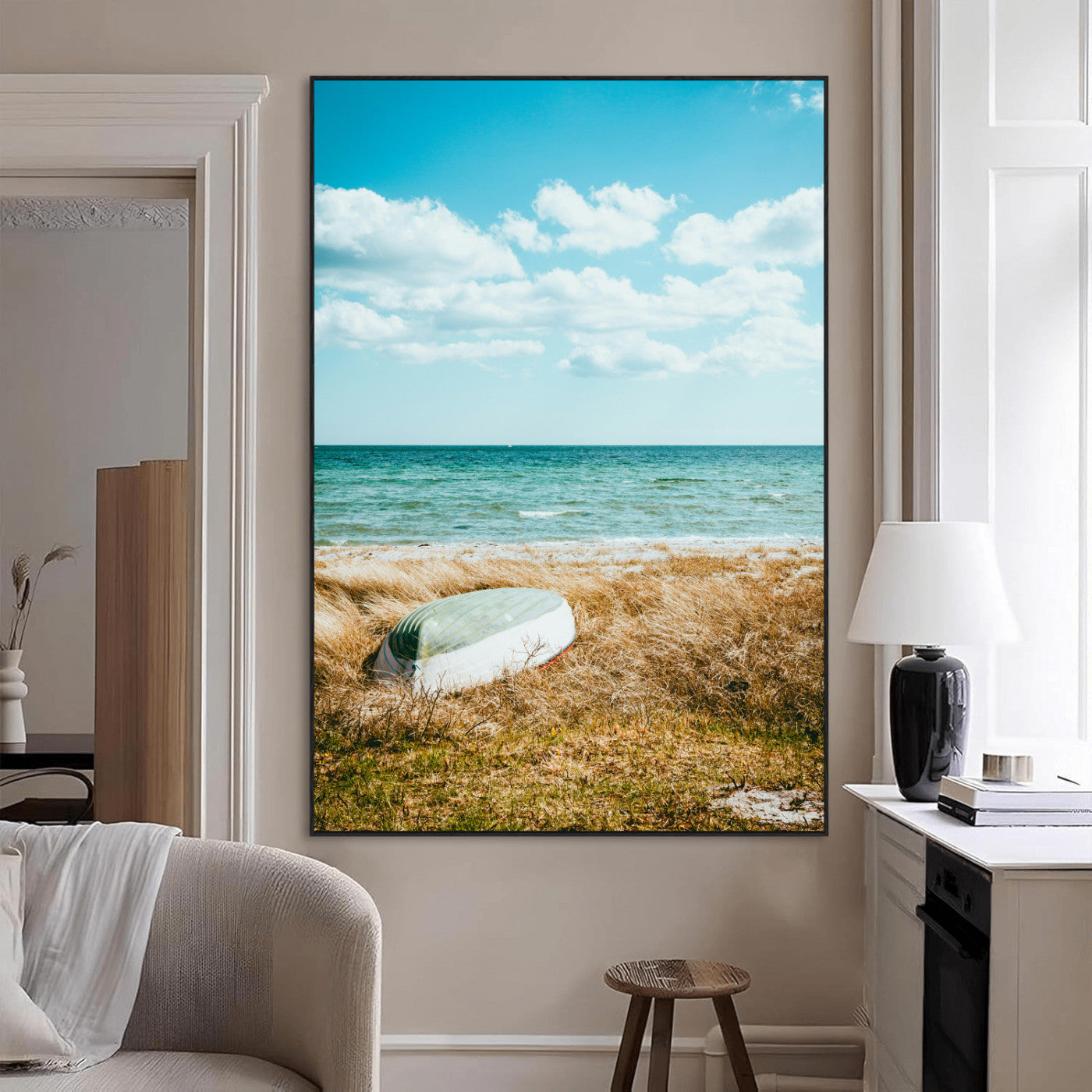 A small boat resting on a grassy shore with ocean waves and a bright blue sky, creating a peaceful coastal atmosphere.