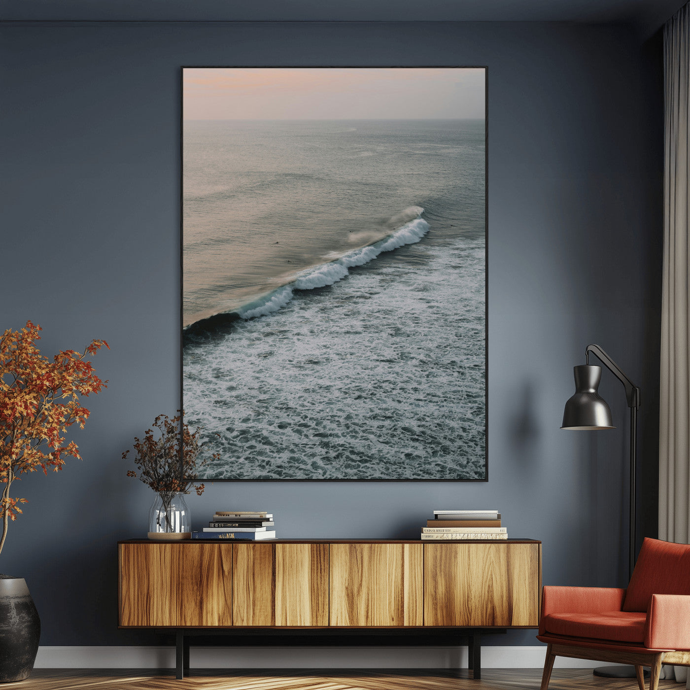 Aerial view of ocean waves rolling towards the shore under a soft sunset sky, creating a peaceful and minimalist coastal scene.