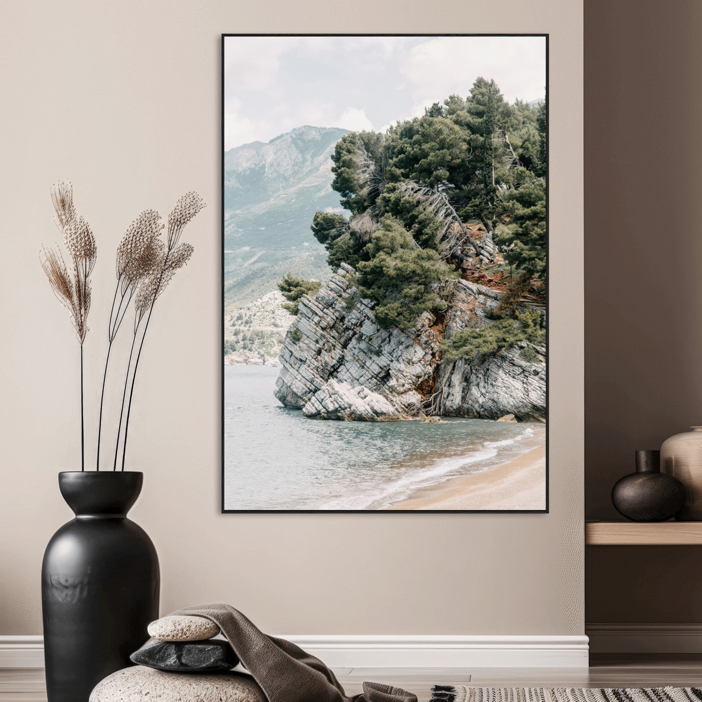 Framed photo of a rocky coastal cliff with dense greenery and calm shoreline, ideal for rustic coastal or earthy-toned home decor.