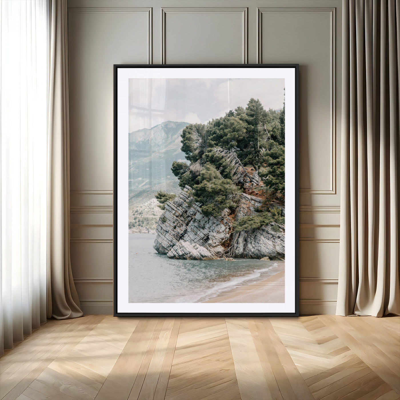 Framed photo of a rocky coastal cliff with dense greenery and calm shoreline, ideal for rustic coastal or earthy-toned home decor.