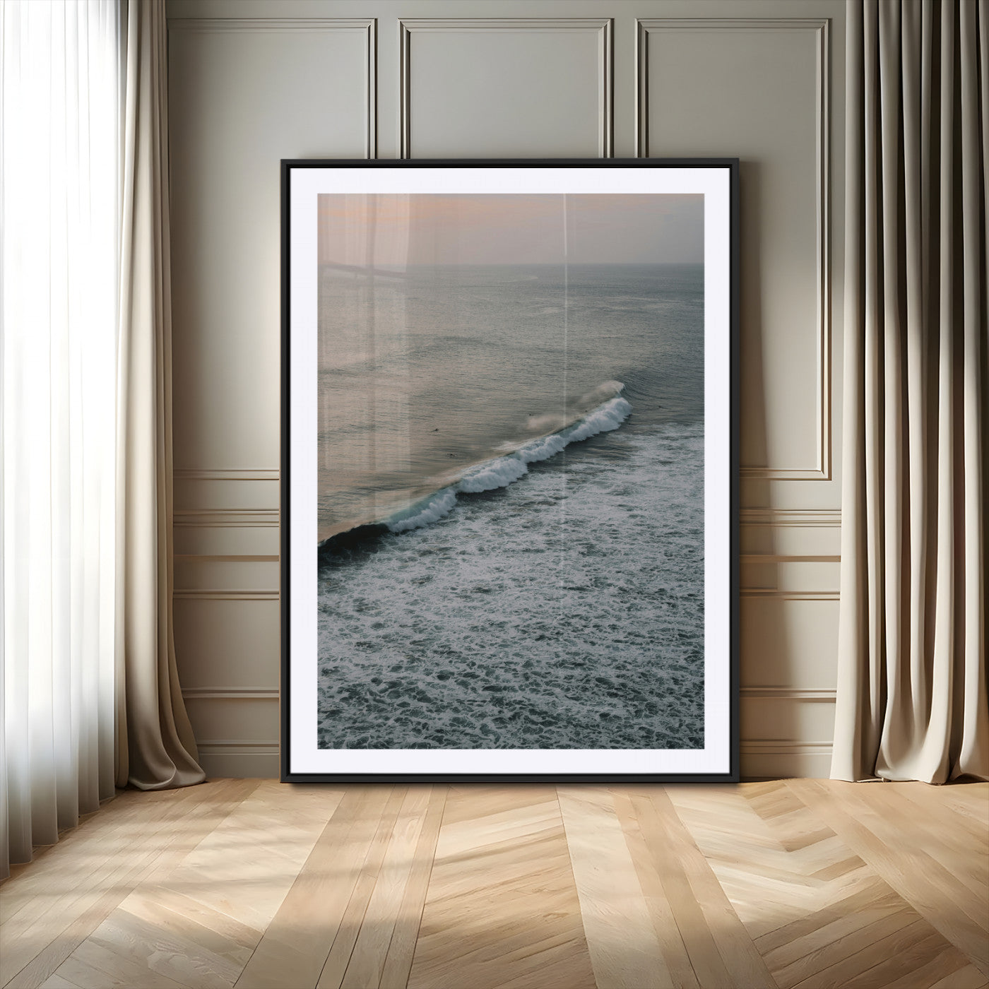 Aerial view of ocean waves rolling towards the shore under a soft sunset sky, creating a peaceful and minimalist coastal scene.