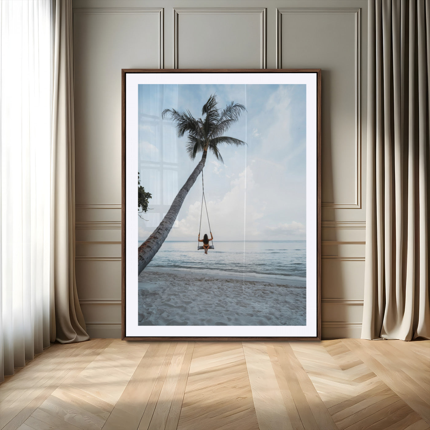 Wall art of a girl on a swing hanging from a palm tree over calm ocean waters, perfect for tropical or minimalist coastal decor.