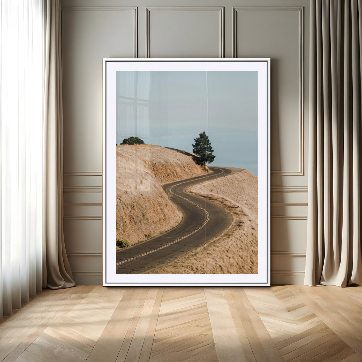 Earth-toned photograph of a winding road through golden hills, ideal for neutral or rustic-themed decor with a calming travel vibe.