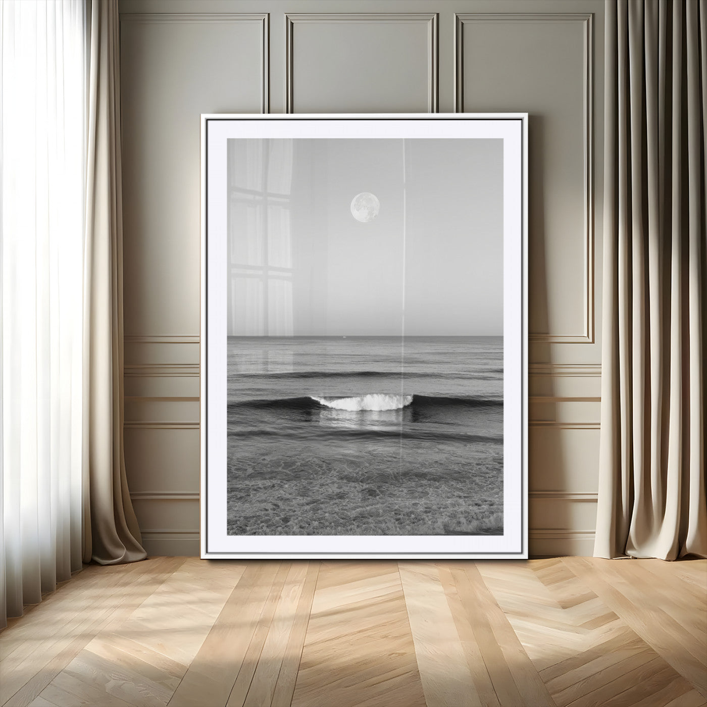 Black and white wall art of a calm ocean wave beneath a full moon, ideal for minimalist or monochrome coastal decor.