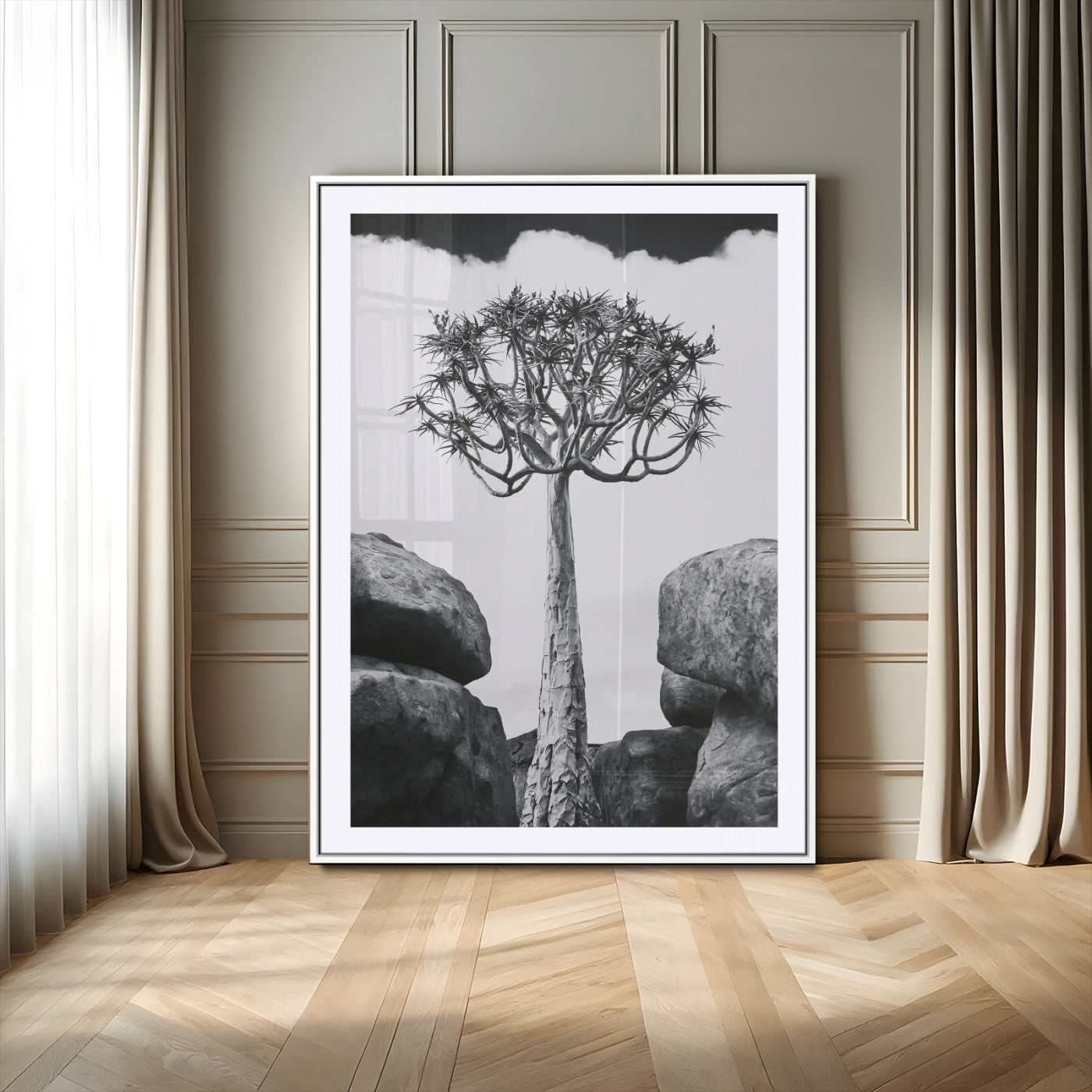 Tall desert tree in black and white, standing between large rocks, perfect for bold and minimalist nature-themed interior spaces.