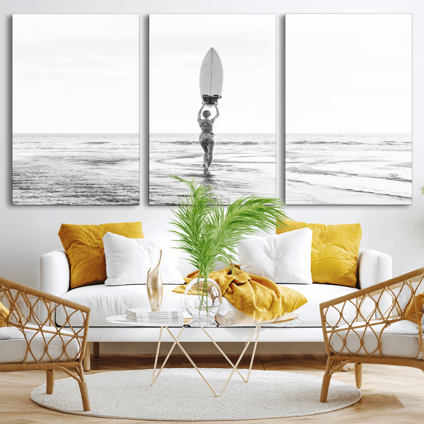 Black and white image of a female surfer holding a surfboard above her head while walking toward the ocean, creating a minimalist and bold coastal aesthetic.