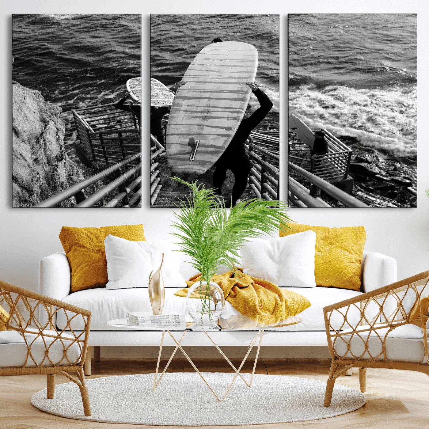 Black and white photo of surfers carrying boards down a rugged cliffside stairway, capturing a bold and adventurous coastal scene.