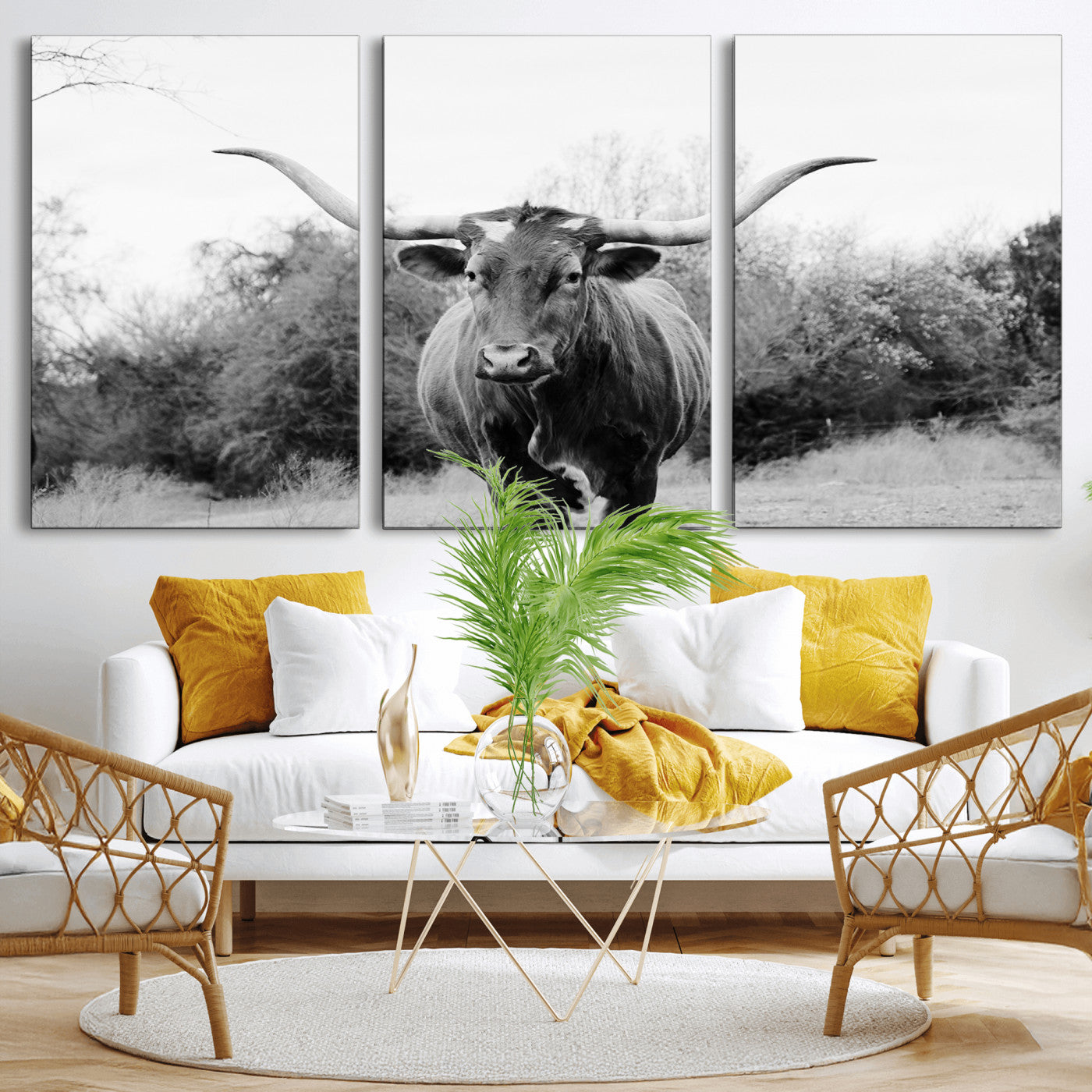 Black and white photo of a longhorn cow in a field, perfect for rustic farmhouse or western-themed interior wall decoration.