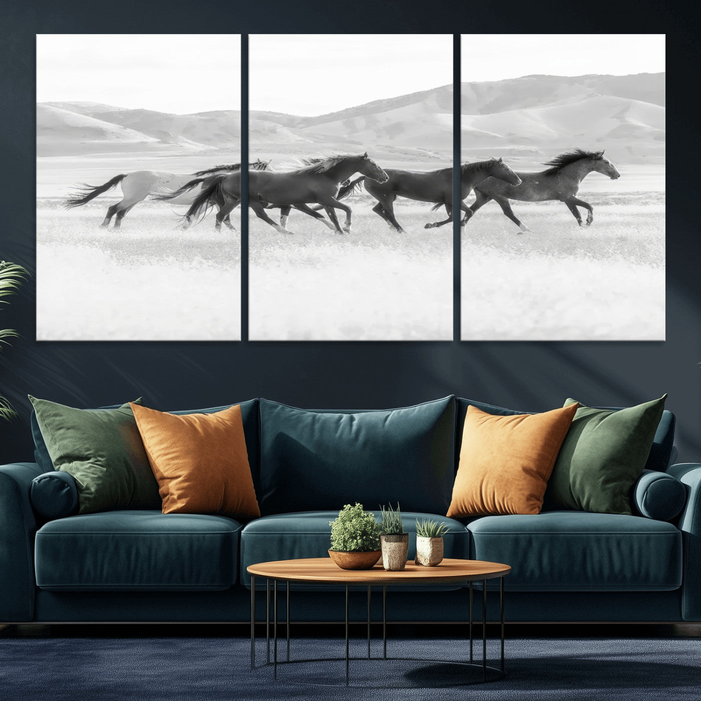 A black and white image of wild horses running freely across an open grassland, capturing the power and beauty of untamed nature in a rustic western setting.