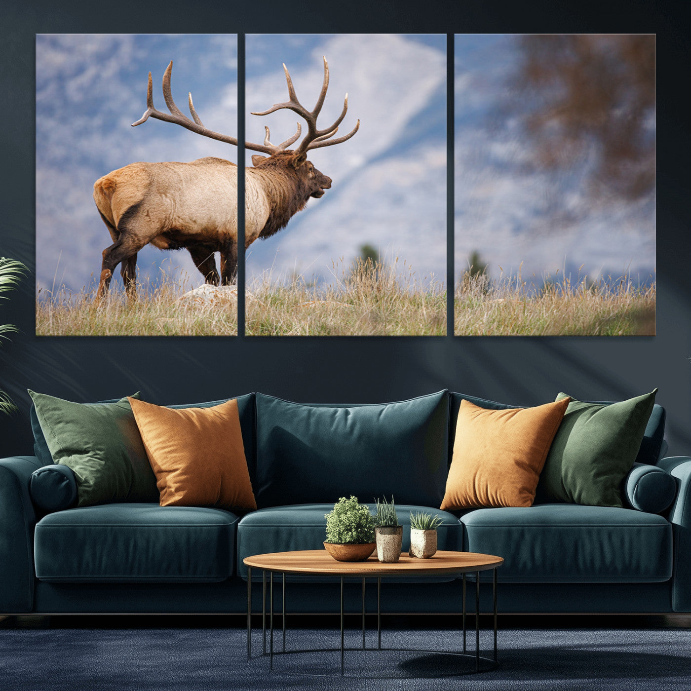 Elk with antlers standing on grass with mountain background, ideal for rustic, cabin, or lodge-inspired wall decor.